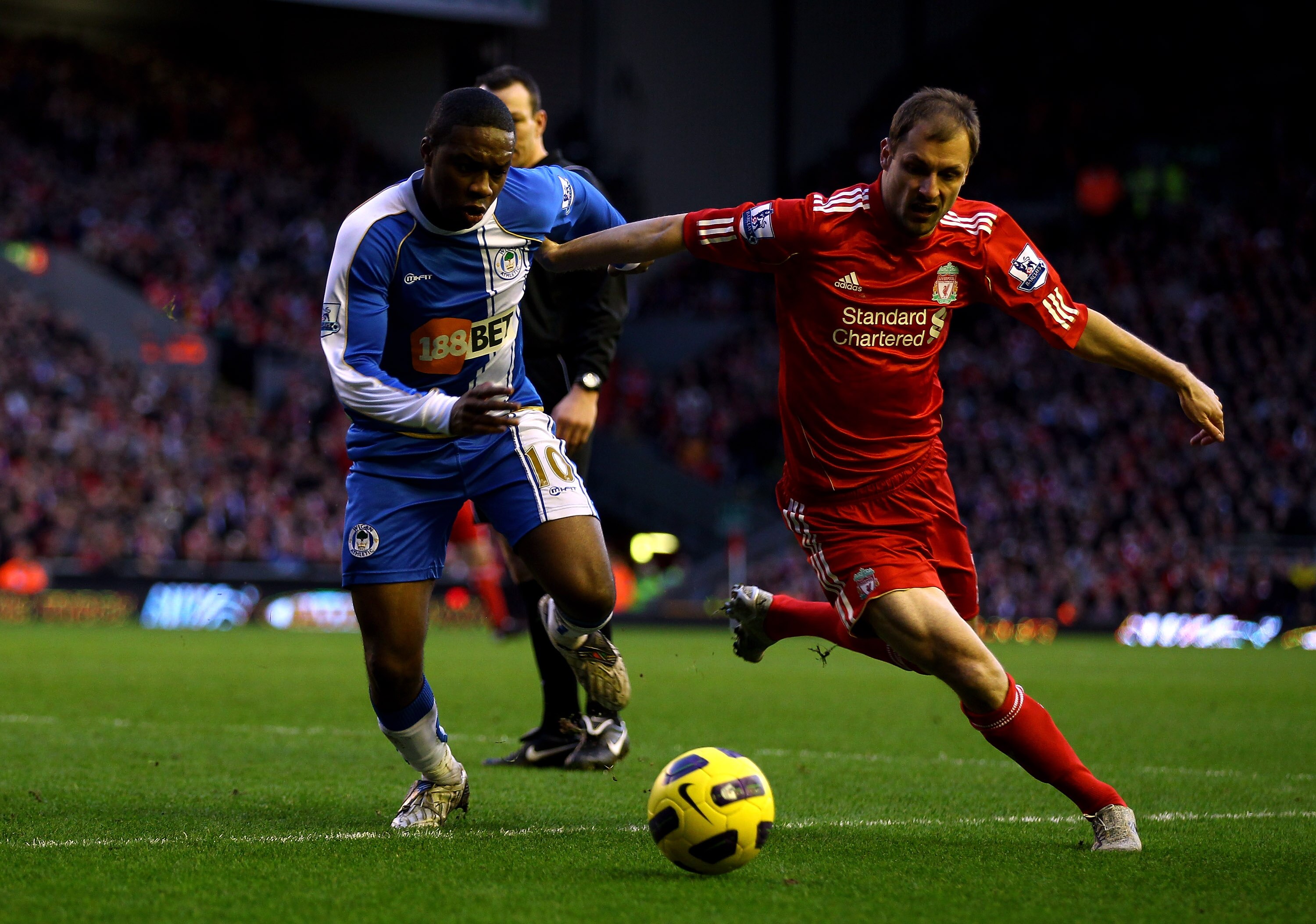 LIVERPOOL, ENGLAND - FEBRUARY 12:  Charles N' Zogbia of Wigan Athletic competes with Milan Jovanovic of Liverpool during the Barclays Premier League match between Liverpool and Wigan Athletic at Anfield on February 12, 2011 in Liverpool, England.  (Photo
