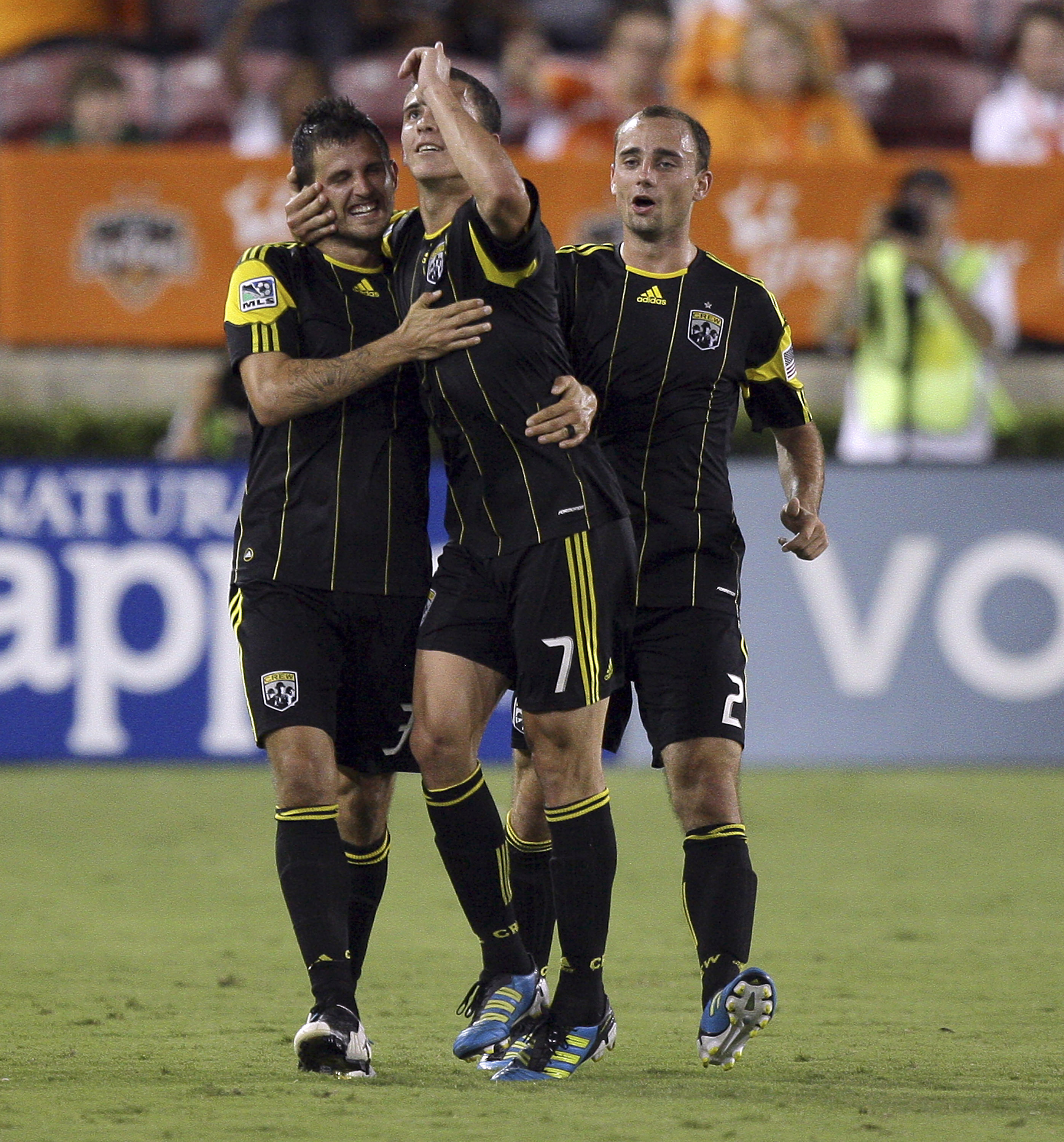 HOUSTON - JUNE 18:  Midfielder Bernardo Anor #7 of the Columbus Crew celebrates with Rich Balchan #2 and Josh Gardner #31 after scoring in the second half against the Houston Dynamo at Robertson Stadium on June 18, 2011 in Houston, Texas. Columbus won 2-0