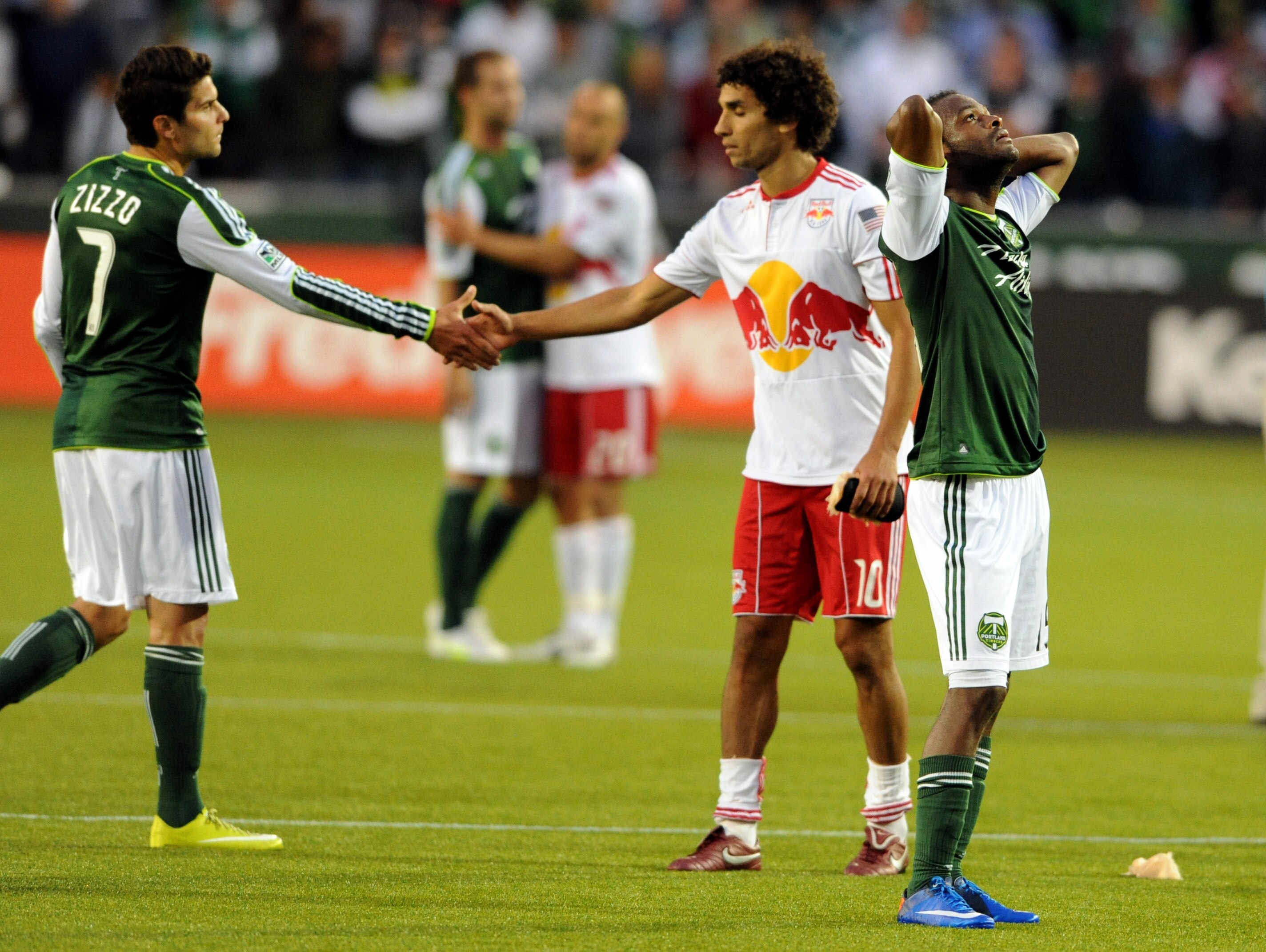 PORTLAND, OR - JUNE 19: Jorge Perlaza #15 of the Portland Timbers looks skyward as Mehdi Ballouchy #10 of the New York Red Bulls and Sal Zizzo #7 of the Portland Timbers shake hands after tthe game at Jeld-Wen Field on June 19, 2011 in Portland, Oregon. T