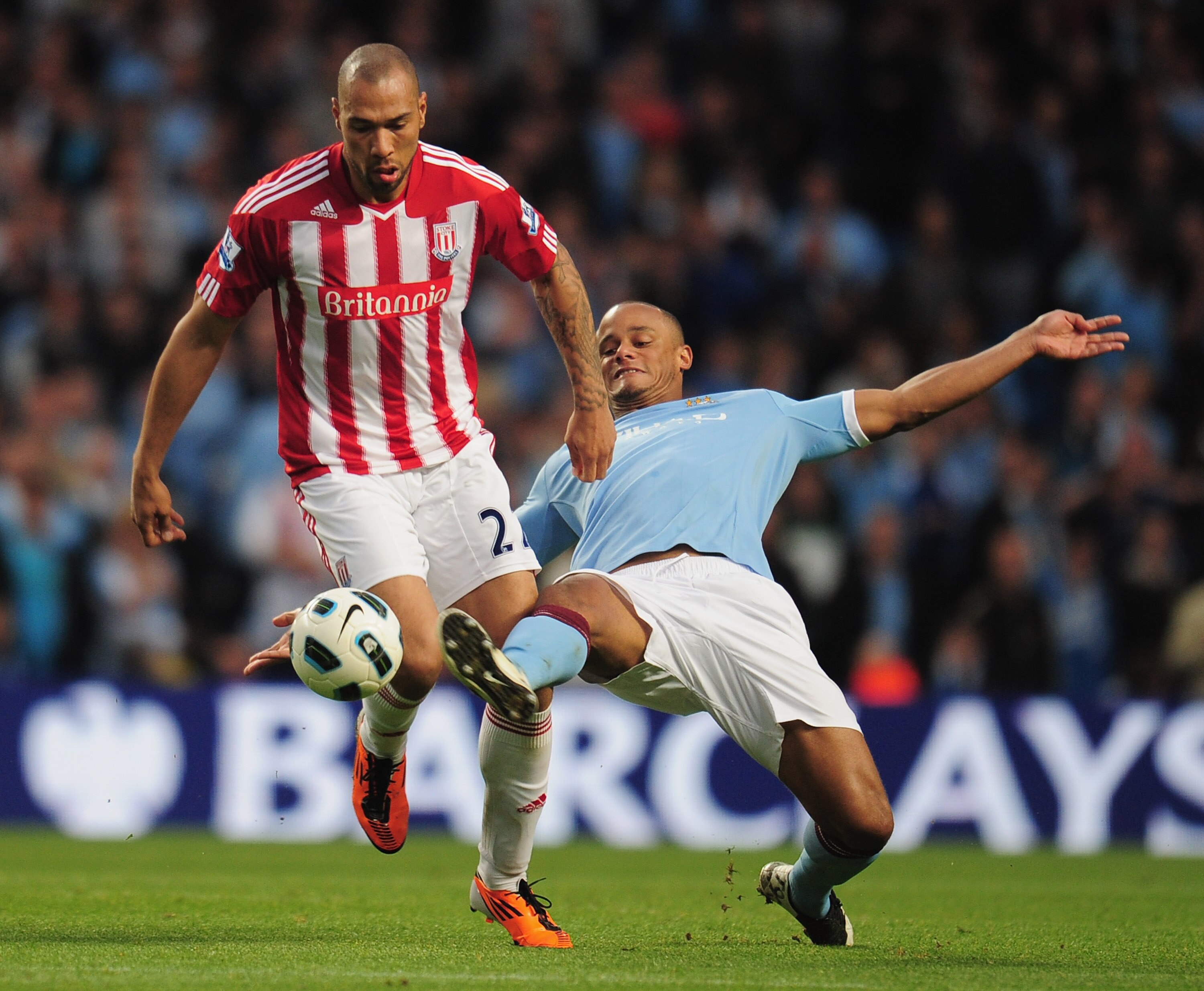MANCHESTER, ENGLAND - MAY 17:  John Carew of Stoke City is tackled by Vincent Kompany of Manchester City during the Barclays Premier League match between Manchester City and Stoke City at City of Manchester Stadium on May 17, 2011 in Manchester, England.