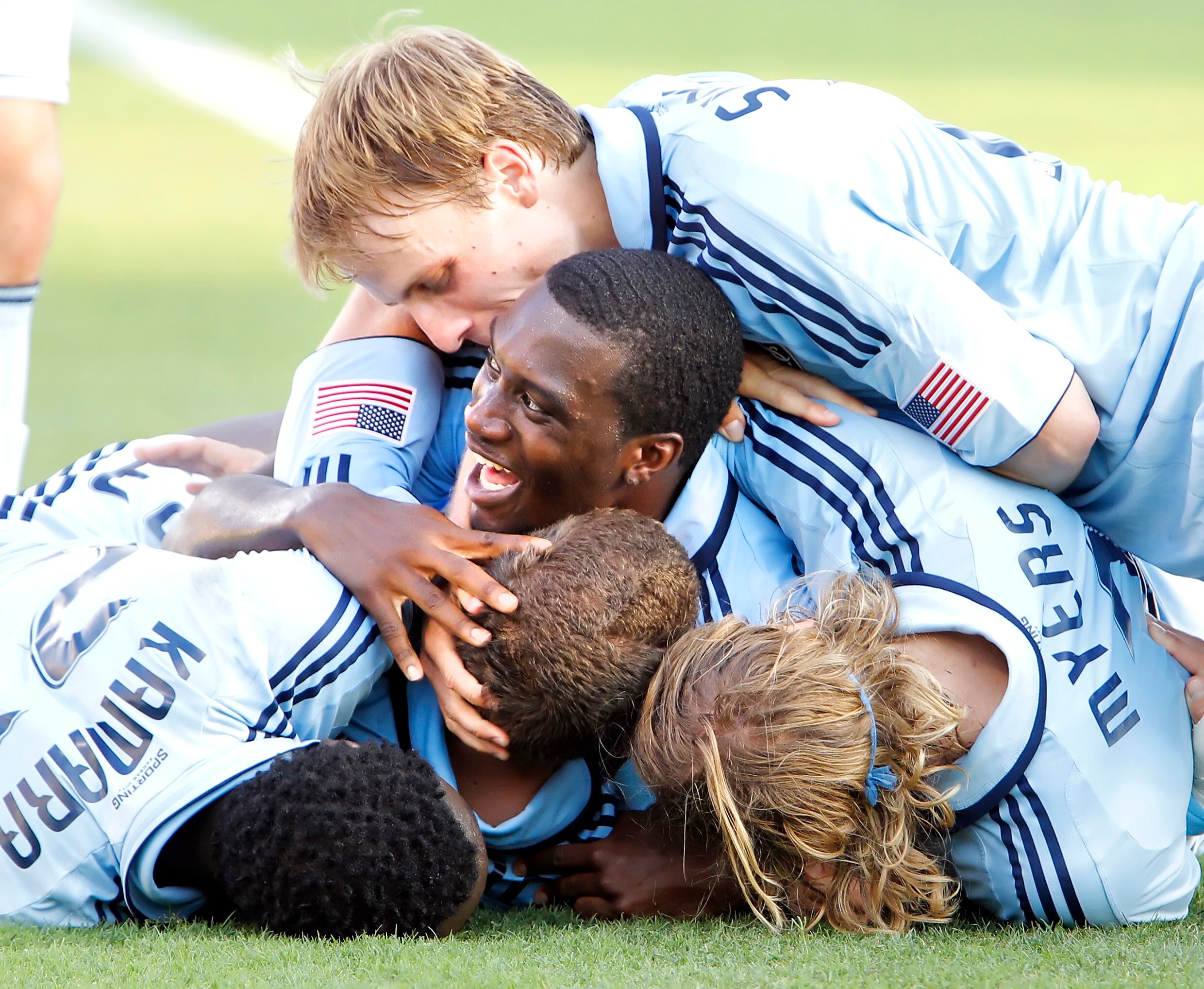 FRISCO, TX - JUNE 12: Luke Sassano #32 of the Sporting KC (bottom center) is swarmed by teammates Chance Myers #7, Seth Sinovic #16, C.J. Sapong #17 and Kei Kamara #23 during the second half of a soccer game at Pizza Hut Park on June 12, 2011 in Frisco, T