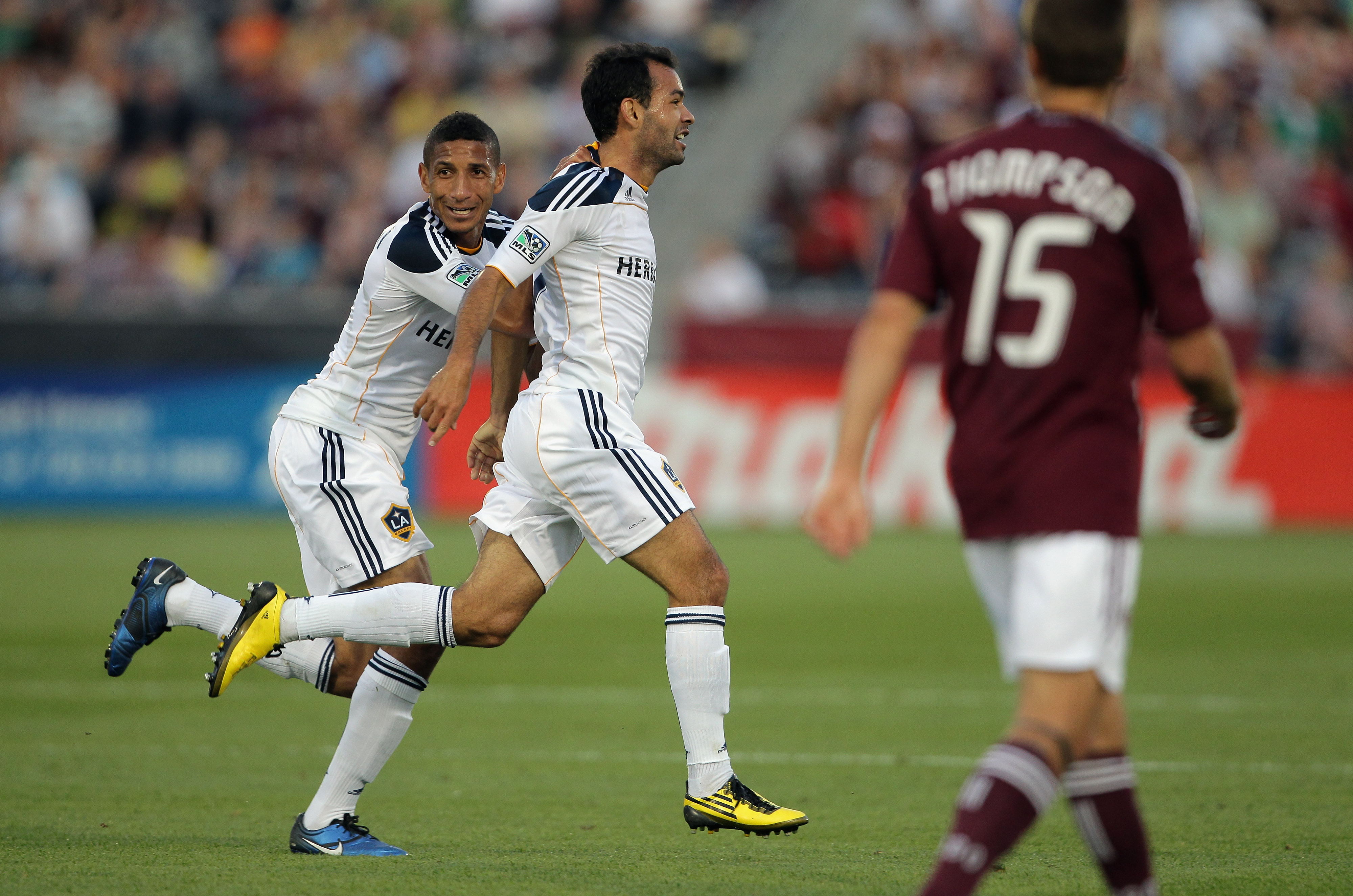 COMMERCE CITY, CO - JUNE 18:  Juninho #19 (C) of the Los Angeles Galaxy celebrates his goal in the 42nd minute with teammate Sean Franklin #5 of the Galaxy as Wells Thompson #15 of the Colorado Rapids looks on as the Galaxy took a 2-0 lead over the Rapids