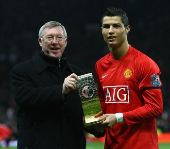 MANCHESTER, UNITED KINGDOM - JANUARY 14:  Cristiano Ronaldo of Manchester United and Manager Sir Alex Ferguson pose with the Fifa World Player of the Year Award won by Ronaldo prior to the Barclays Premier League match between Manchester United and Wigan