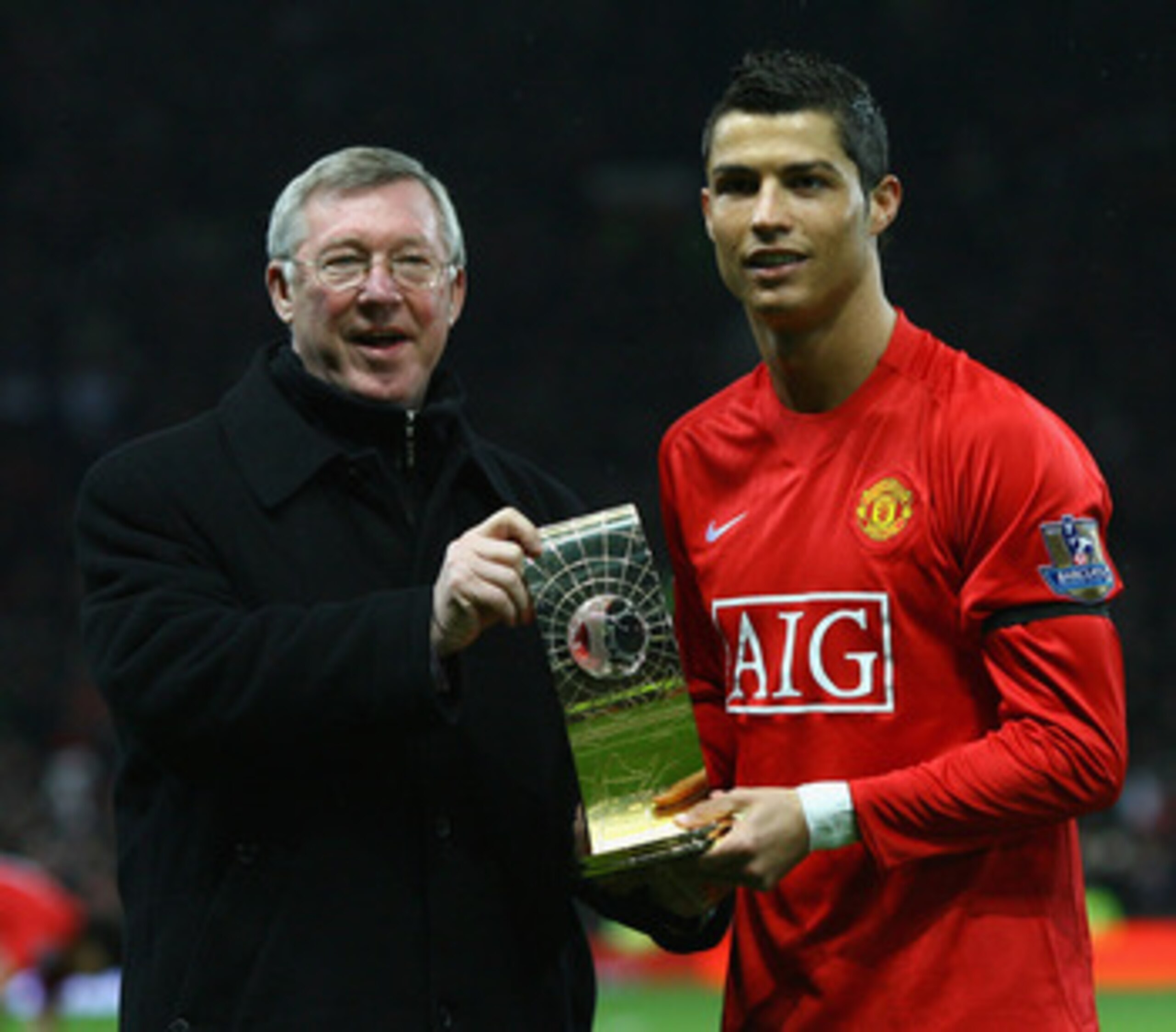 MANCHESTER, UNITED KINGDOM - JANUARY 14:  Cristiano Ronaldo of Manchester United and Manager Sir Alex Ferguson pose with the Fifa World Player of the Year Award won by Ronaldo prior to the Barclays Premier League match between Manchester United and Wigan
