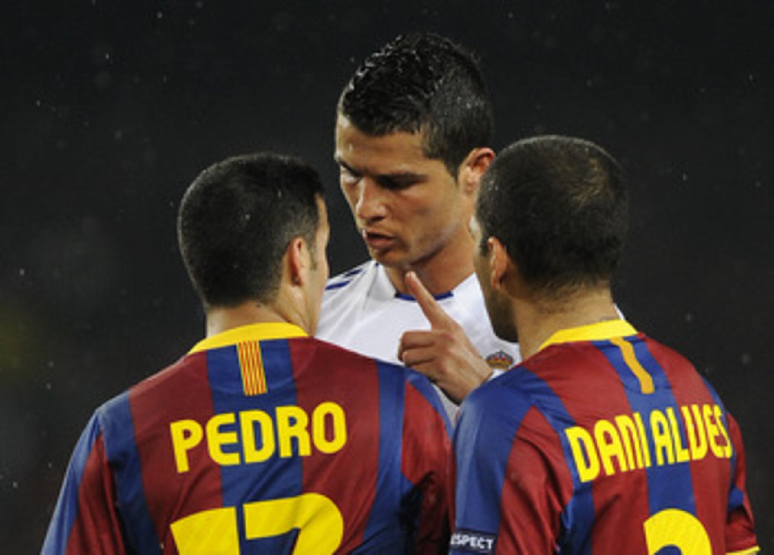 BARCELONA, SPAIN - MAY 03:  Cristiano Ronaldo of Real Madrid (C) argues with Pedro Rodriguez (L) and Dani Alves of FC Barcelona during the UEFA Champions League Semi Final second leg match between Barcelona and Real Madrid at the Camp Nou on May 3, 2011 i