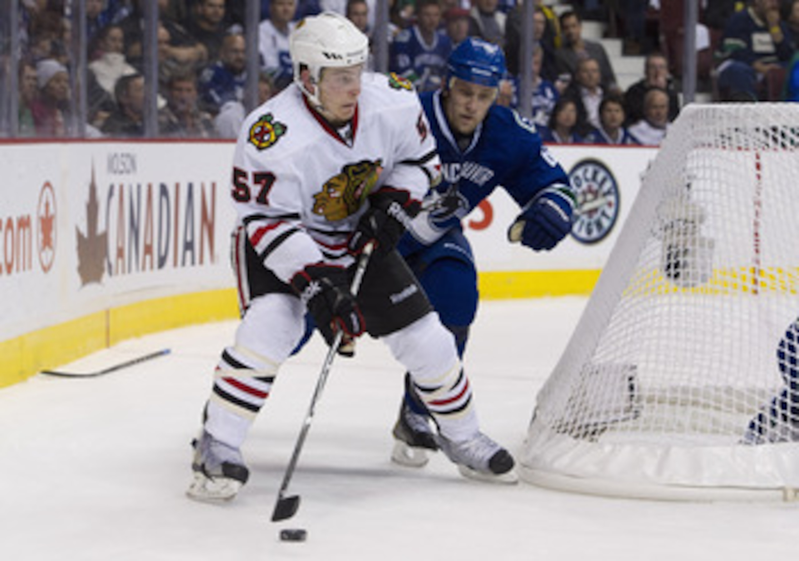 VANCOUVER, CANADA - APRIL 13: Ben Smith #57of the Chicago Blackhawks skate towards the goal while being chased by Sami Salo #6 of the Vancouver Canucks during the second period in Game One of the Western Conference Quarterfinals during the 2011 NHL Stanle