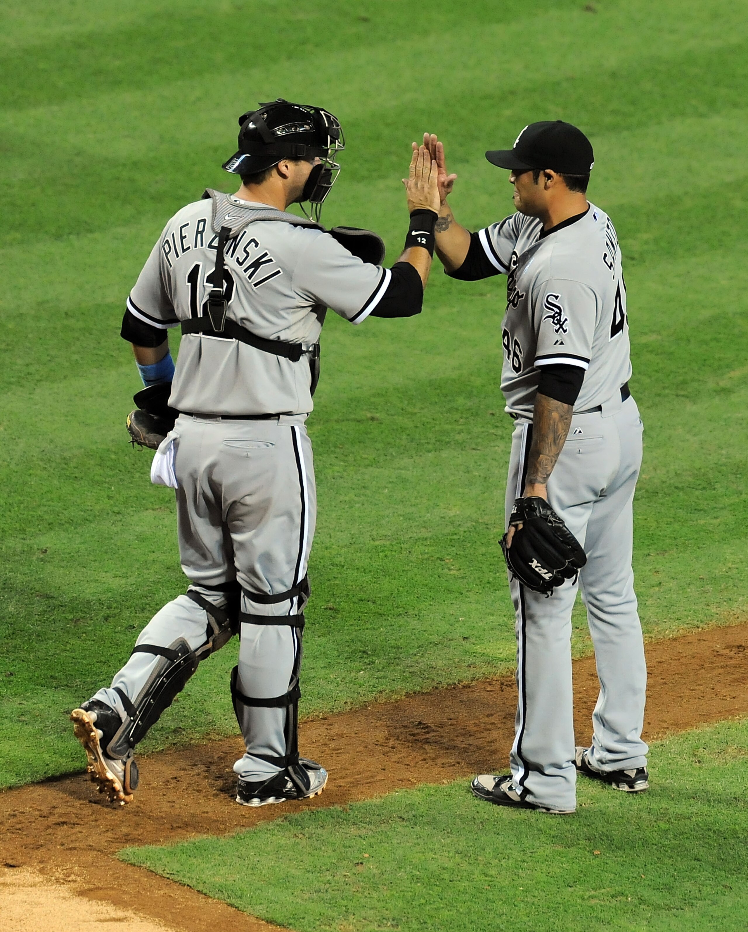 PHOENIX, AZ - JUNE 19:  A.J. Pierzynski #12 of the Chicago White Sox congratulates Sergio Santos #46 after closing out the ninth inning against the Arizona Diamondbacks at Chase Field on June 19, 2011 in Phoenix, Arizona.  (Photo by Norm Hall/Getty Images