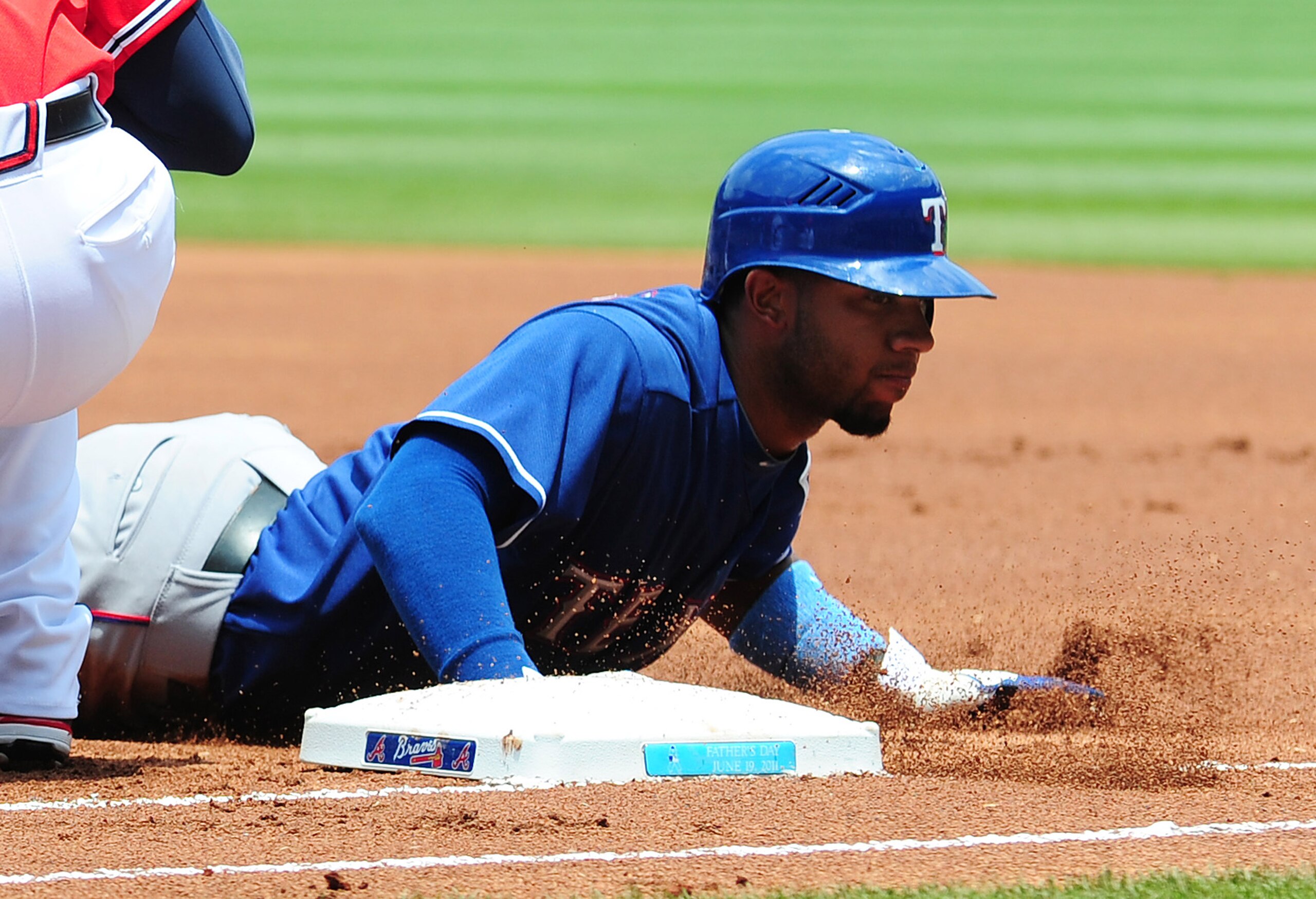 ATLANTA - JUNE 19: Elvis Andrus #1 of the Texas Rangers dives back to first base against the Atlanta Braves at Turner Field on June 19, 2011 in Atlanta, Georgia. (Photo by Scott Cunningham/Getty Images)