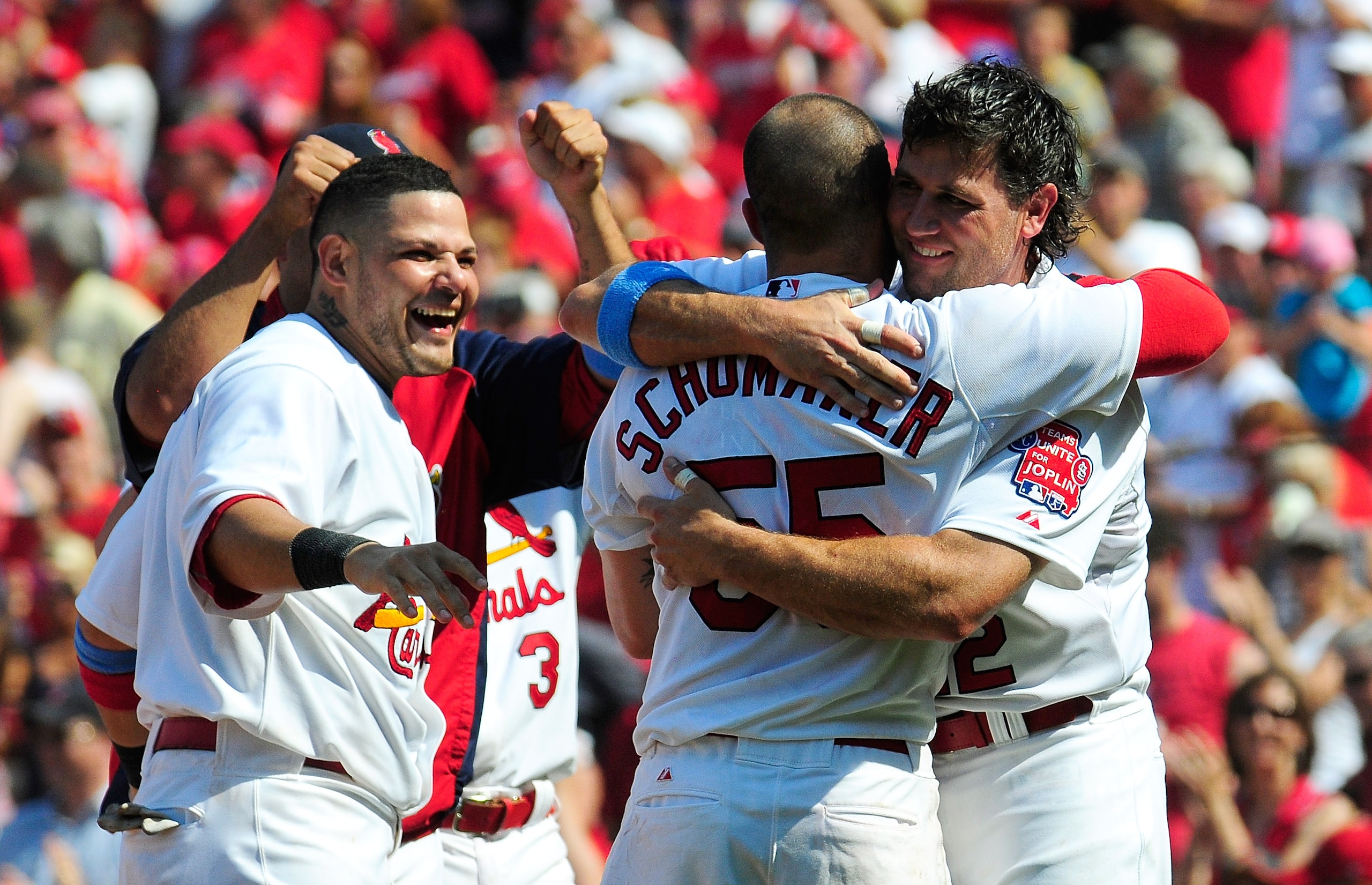 ST. LOUIS, MO - JUNE 19: Skip Schumaker #55 of the St. Louis Cardinals hugs Lance Berkman #12 after hitting a walk off home run against the Kansas City Royals at Busch Stadium on June 19, 2011 in St. Louis, Missouri.  (Photo by Jeff Curry/Getty Images)