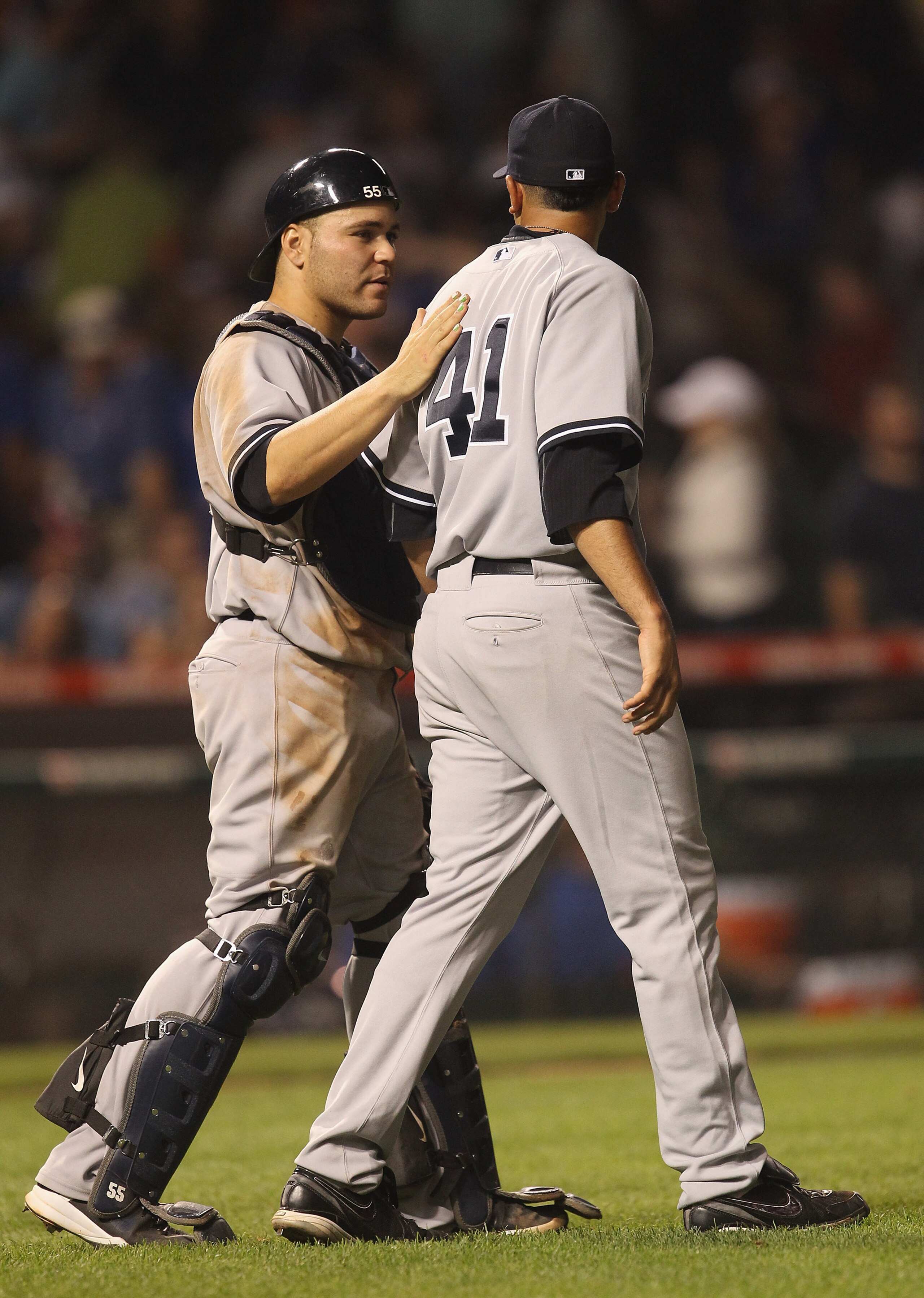 CHICAGO, IL - JUNE 19:  Jeff Marquez #41 of the New York Yankees receives a pat on the back from teammate Russell Martin #55 after a win against the Chicago Cubs at Wrigley Field on June 19, 2011 in Chicago, Illinois. The Yankees defeated the Cubs 10-4.