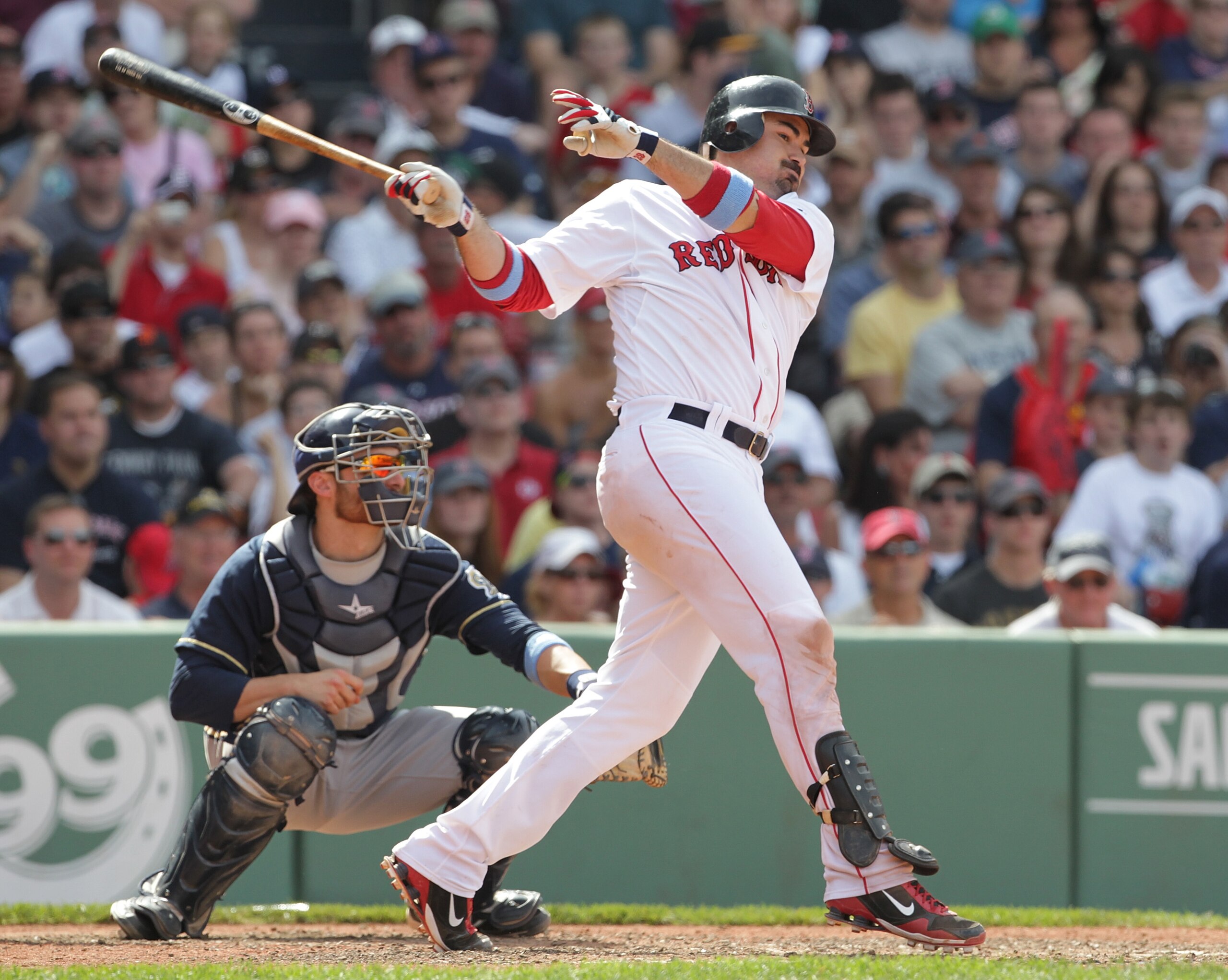 BOSTON, MA  - JUNE 19:  Adrian Gonzalez #28 of the Boston Red Sox knocks in a run during a game against the Milwaukee Brewers at Fenway Park on June 19, 2011 in Boston, Massachusetts.  (Photo by Jim Rogash/Getty Images)