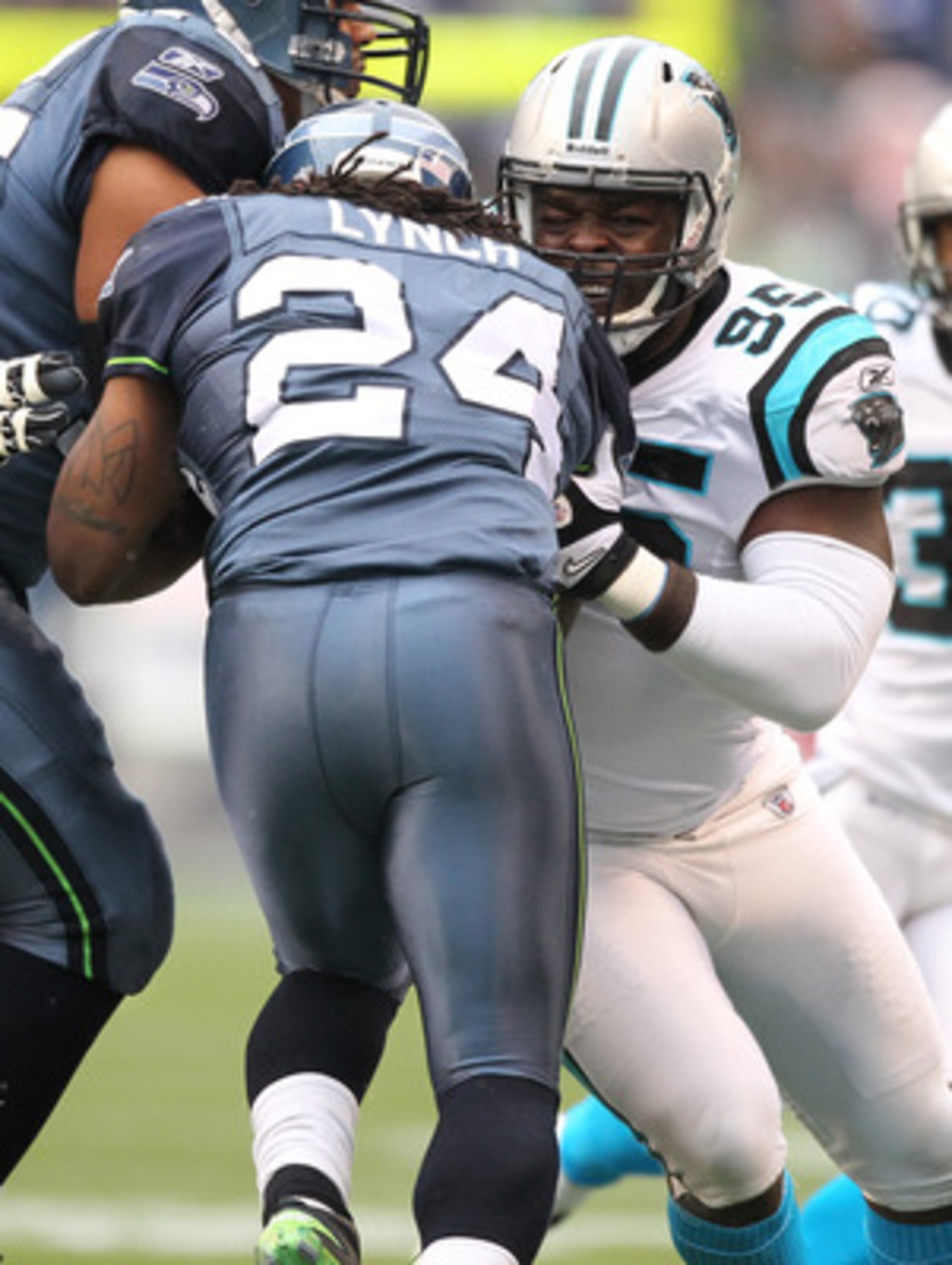 SEATTLE - DECEMBER 05:  Running back Marshawn Lynch #24 of the Seattle Seahawks rushes against Charles Johnson #95 of the Carolina Panthers at Qwest Field on December 5, 2010 in Seattle, Washington. The Seahawks won, 31-14. (Photo by Otto Greule Jr/Getty