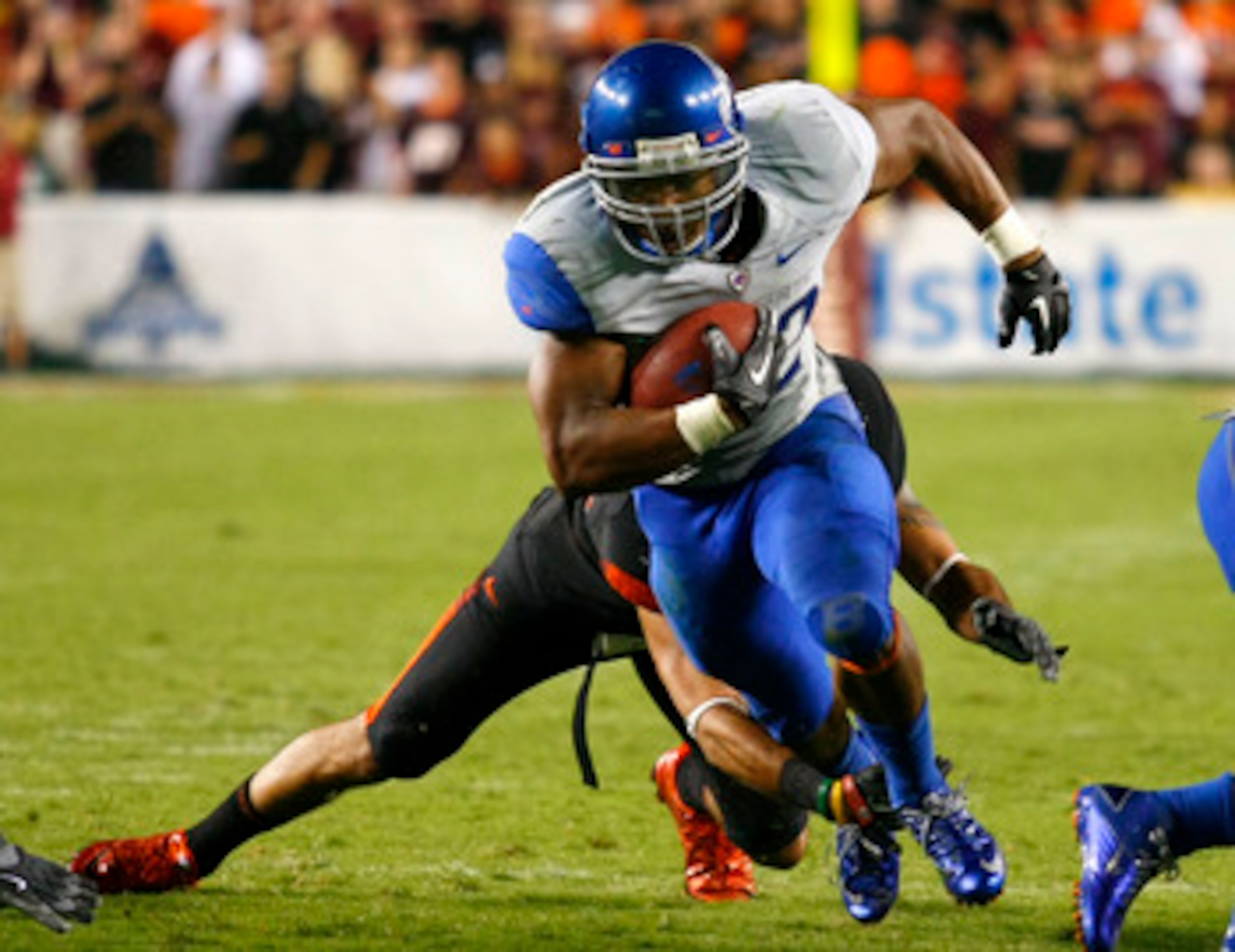 LANDOVER, MD - SEPTEMBER 06:  Running back #22 Doug Martin of the Boise State Broncos runs past linebacker #43 Jeron Gouveia-Winslow of the Virginia Tech Hokies at FedExField on September 6, 2010 in Landover, Maryland.  (Photo by Geoff Burke/Getty Images)