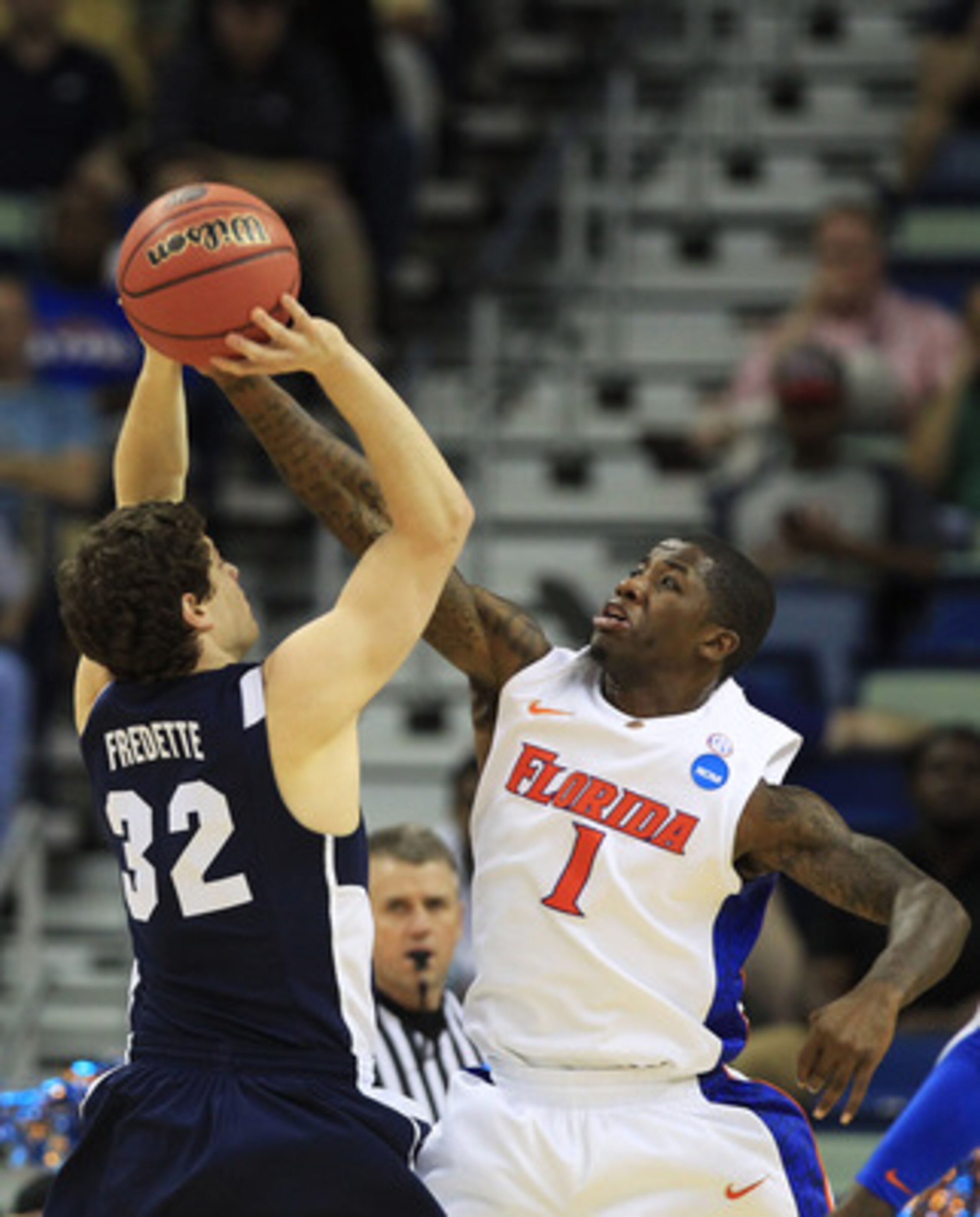 NEW ORLEANS, LA - MARCH 24:  Jimmer Fredette #32 of the Brigham Young Cougars shoots against Kenny Boynton #1 of the Florida Gators in the first half during the Southeast regional of the 2011 NCAA men's basketball tournament at New Orleans Arena on March 