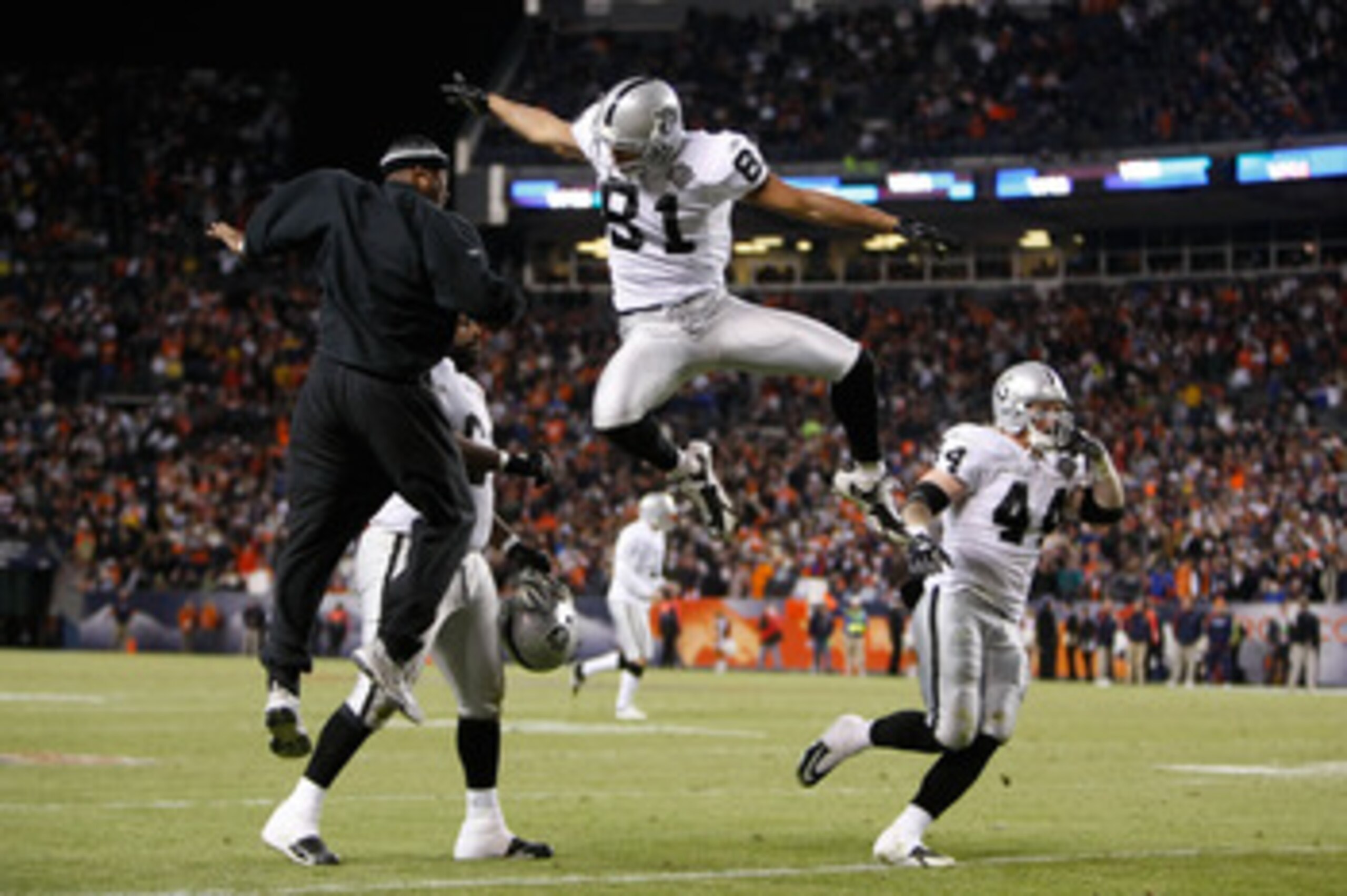 DENVER - DECEMBER 20:  Chaz Schilens #81 of the Oakland Raiders is congratulated by Javon Walker (L) after scoring a touchdown late in the fourth quarter against the Denver Broncos at Invesco Field at Mile High on December 20, 2009 in Denver, Colorado. Th