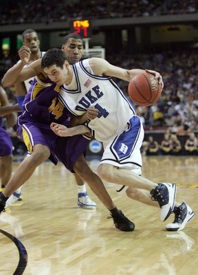 ATLANTA - MARCH 23:  J.J. Redick #4 of the Duke Blue Devils dribbles against Garrett Temple #14 of the LSU Tigers during third round game of the 2006 NCAA Division I Men's Basketball Tournament Regional at the Georgia Dome on March 23, 2006 in Atlanta, Ge