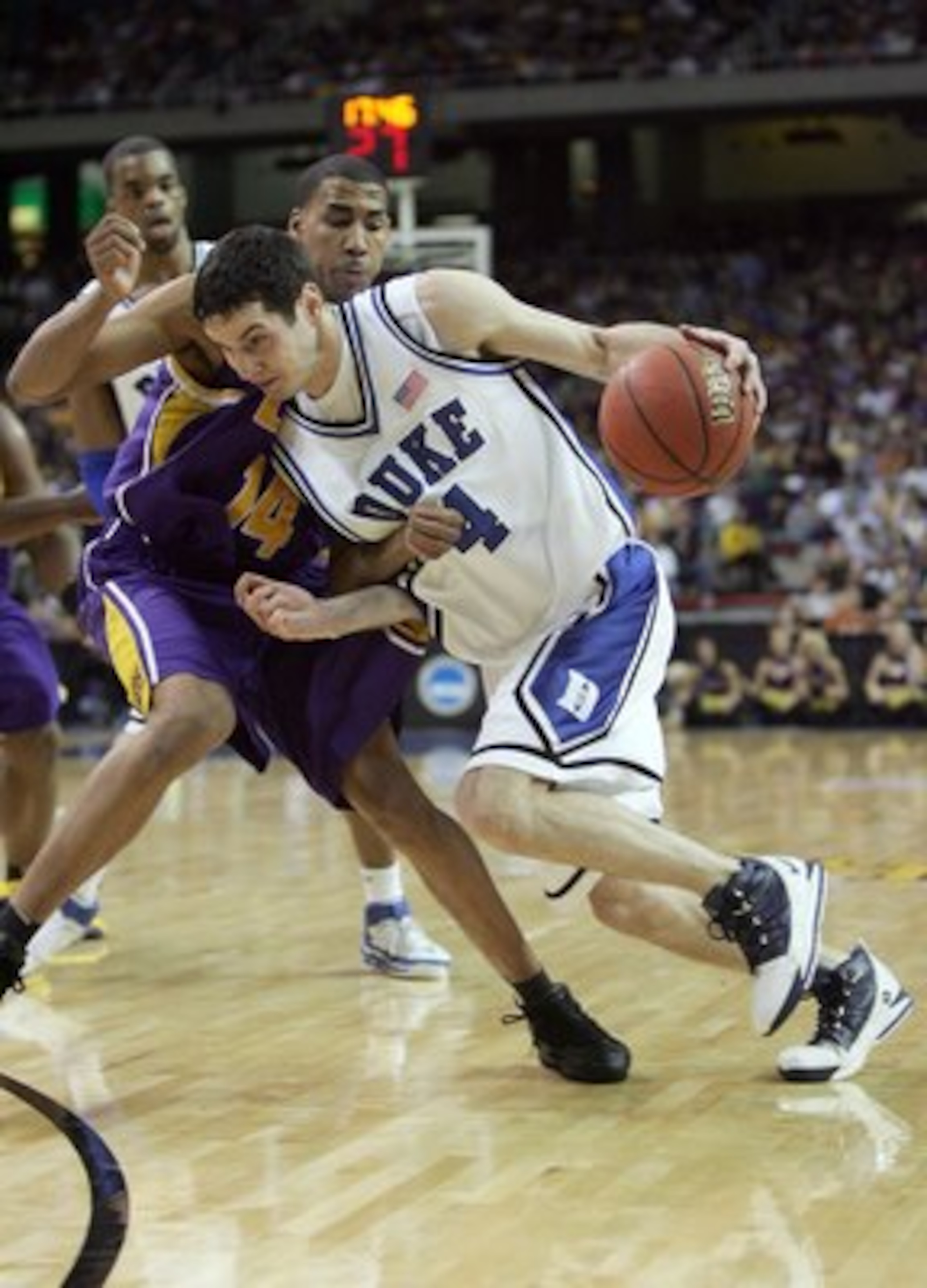 ATLANTA - MARCH 23: J.J. Redick #4 of the Duke Blue Devils dribbles against Garrett Temple #14 of the LSU Tigers during third round game of the 2006 NCAA Division I Men's Basketball Tournament Regional at the Georgia Dome on March 23, 2006 in Atlanta, Ge ATLANTA - MARCH 23: J.J. Redick #4 of the Duke Blue Devils dribbles against Garrett Temple #14 of the LSU Tigers during third round game of the 2006 NCAA Division I Men's Basketball Tournament Regional at the Georgia Dome on March 23, 2006 in Atlanta, Ge