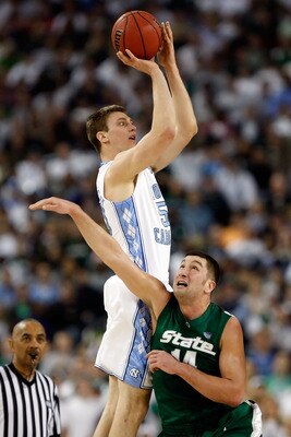 DETROIT - APRIL 06:  Tyler Hansbrough #50 of the North Carolina Tar Heels goes up for a shot over Goran Suton #14 of the Michigan State Spartans in the first half during the 2009 NCAA Division I Men's Basketball National Championship game at Ford Field on