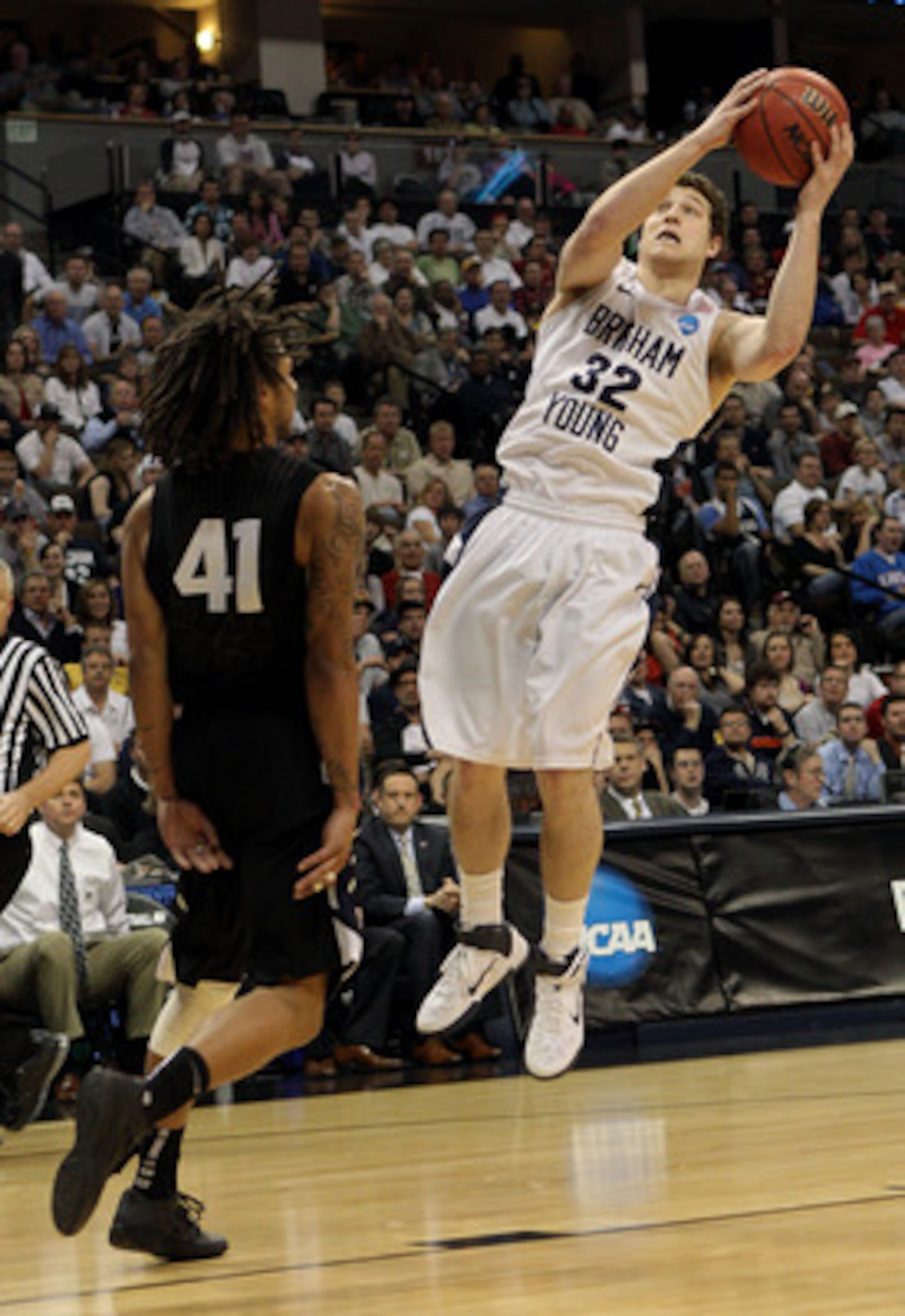 DENVER, CO - MARCH 19:  Jimmer Fredette #32 of the Brigham Young Cougars goes to the hoop against Steven Gray #41 of the Gonzaga Bulldogs during the third round of the 2011 NCAA men's basketball tournament at Pepsi Center on March 19, 2011 in Denver, Colo