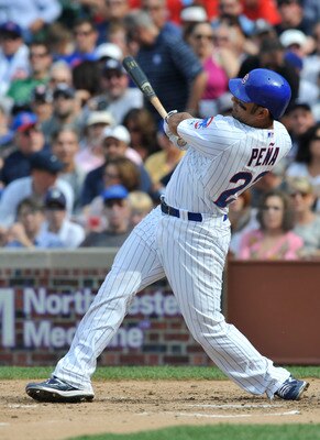 CHICAGO, IL - JUNE 18:  Carlos Pena # 22 of the Chicago Cubs hits a 2-run home run against the New York Yankees in the fourth inning on June 18, 2011 at Wrigley Field in Chicago, Illinois.  (Photo by David Banks/Getty Images)