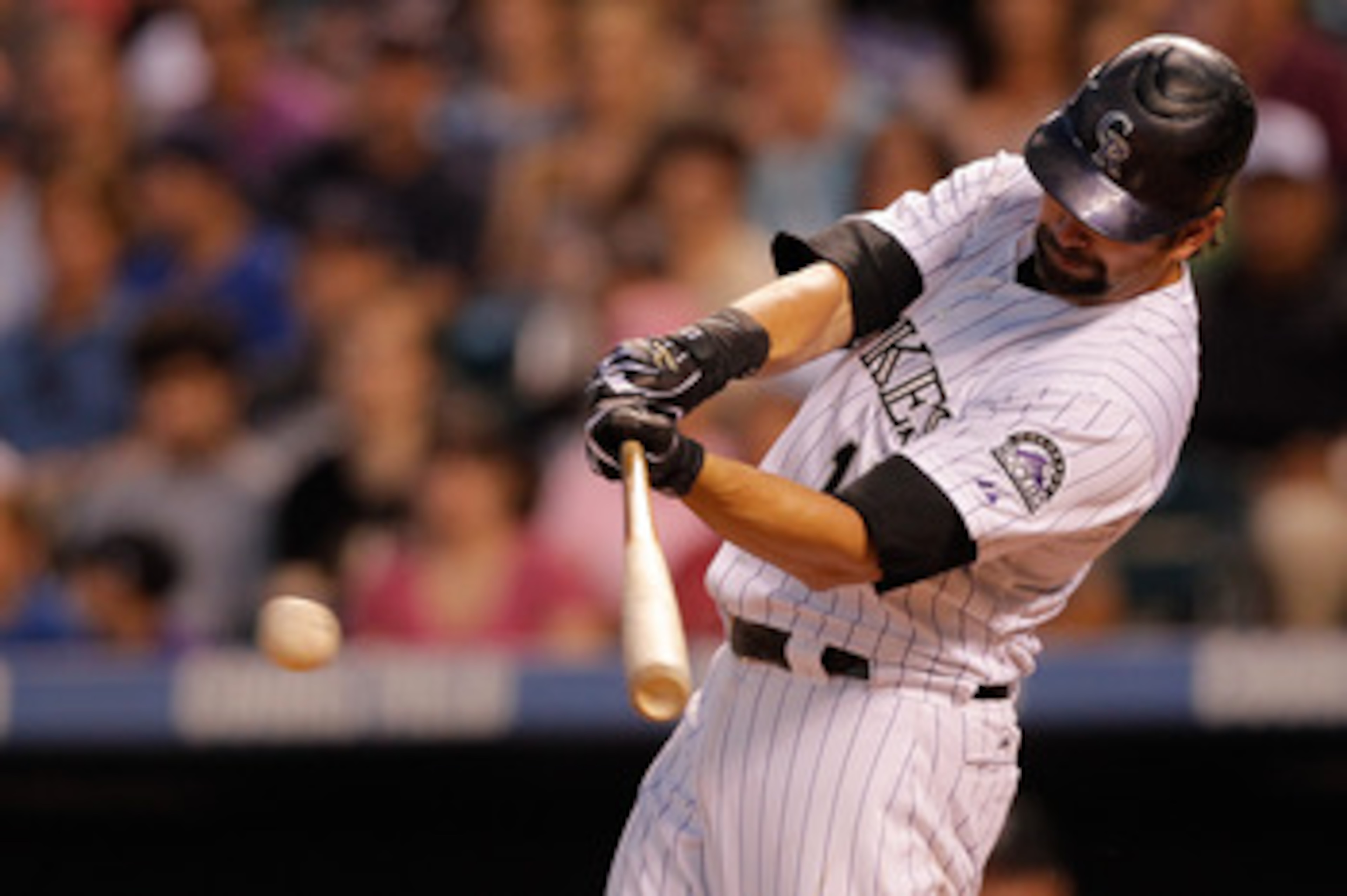 DENVER, CO - JUNE 14:  Todd Helton #17 of the Colorado Rockies singles to center field off of Wade LeBlanc of the San Diego Padres in the sixth inning at Coors Field on June 14, 2011 in Denver, Colorado. (Photo by Justin Edmonds/Getty Images)