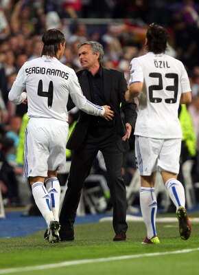 MADRID, SPAIN - APRIL 05:  Jose Mourinho of Real Madrid reacts to Sergio Ramos after Emmanuel Adebayor scores the opener the UEFA Champions League Quarter Final first leg match between Real Madrid and Tottenham Hotspur at Estadio Santiago Bernabeu on Apri