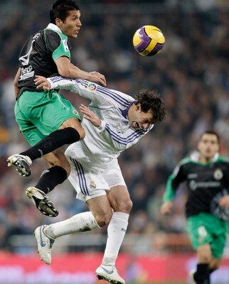 MADRID, SPAIN - DECEMBER 01:  Ruud van Nistelrooy (R) of Real Madrid duels for the ball with Ezequiel Garay of Racing Santander during the La Liga match between Real Madrid and Racing Santander at the Santiago Bernabeu Stadium on December 1, 2007 in Madri