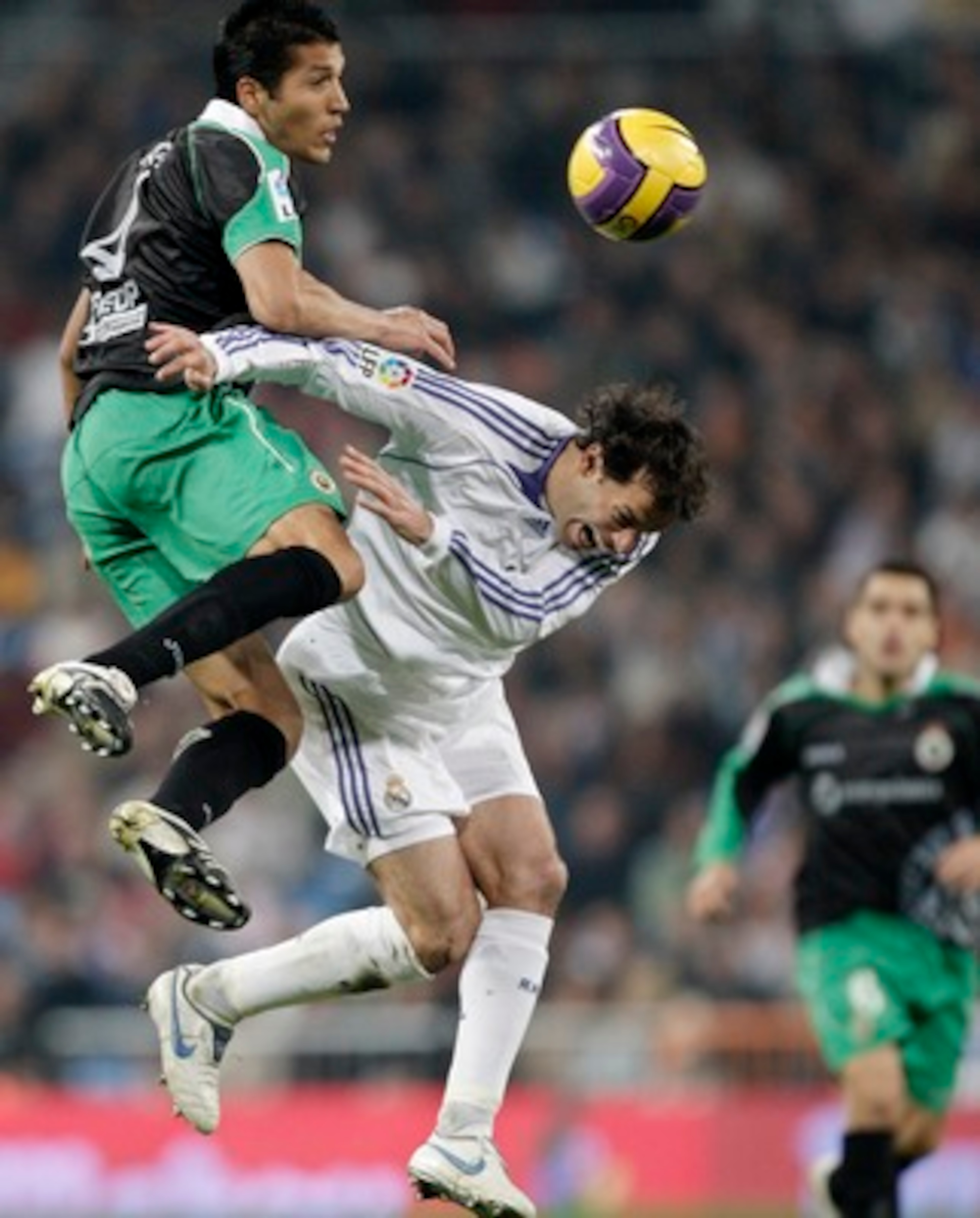 MADRID, SPAIN - DECEMBER 01:  Ruud van Nistelrooy (R) of Real Madrid duels for the ball with Ezequiel Garay of Racing Santander during the La Liga match between Real Madrid and Racing Santander at the Santiago Bernabeu Stadium on December 1, 2007 in Madri