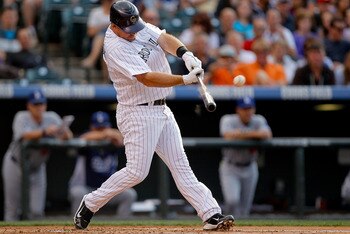 DENVER, CO - JUNE 11:  Ty Wigginton #21 of the Colorado Rockies hits a solo home run off of starting pitcher Ted Lilly of the Los Angeles Dodgers in the second inning at Coors Field on June 11, 2011 in Denver, Colorado. The Dodgers defeated the Rockies 11