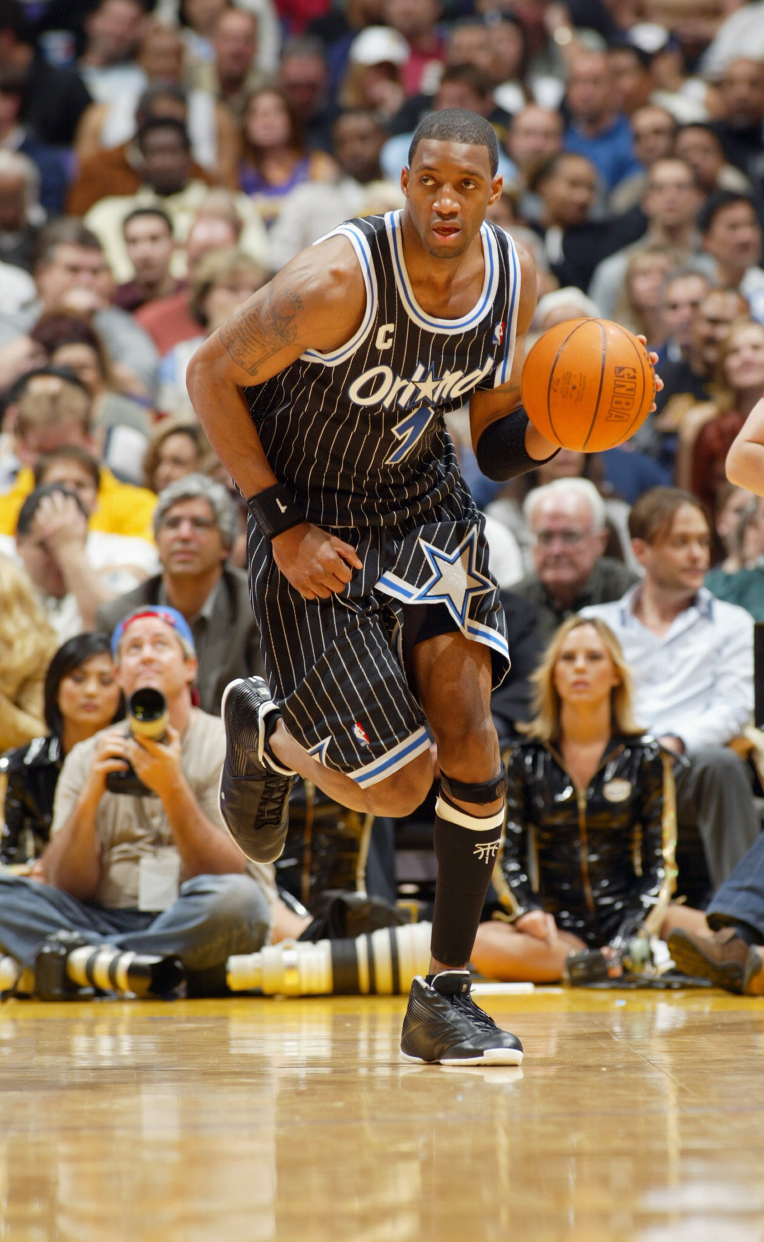 LOS ANGELES - MARCH 15:  Tracy McGrady  #1 of the Orlando Magic drives upcourt during the game against the Los Angeles Lakers at Staples Center on March 15, 2004 in Los Angeles, California.  The Lakers won 113-110.   NOTE TO USER: User expressly acknowled