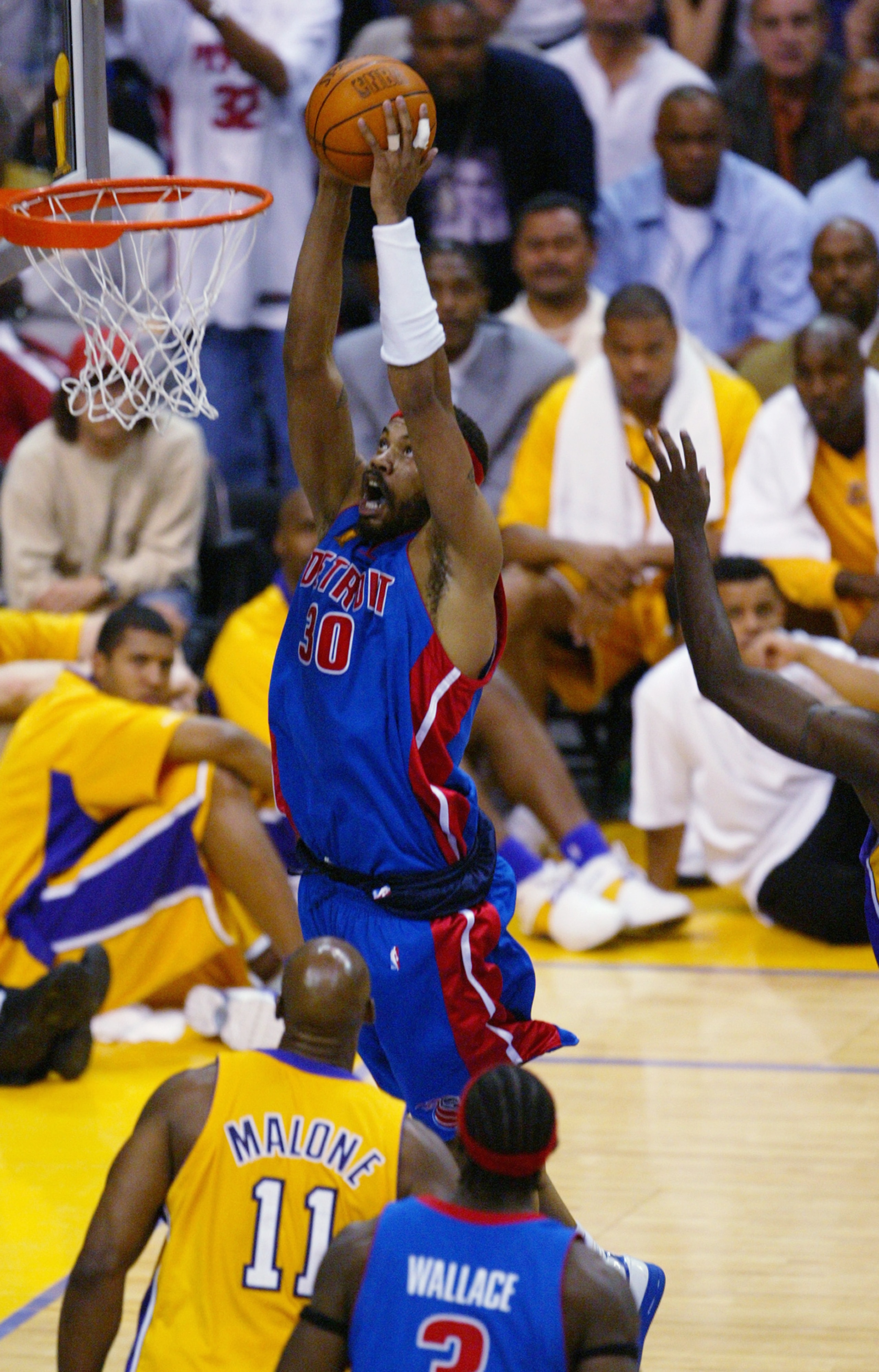 LOS ANGELES - JUNE 8:  Rasheed Wallace #30 of the Detroit Pistons dunks over Karl Malone #11 of the Los Angeles Lakers in Game two of the 2004 NBA Finals at Staples Center on June 8, 2004 in Los Angeles, California.  The Lakers won in overtime 99-91.  NOT