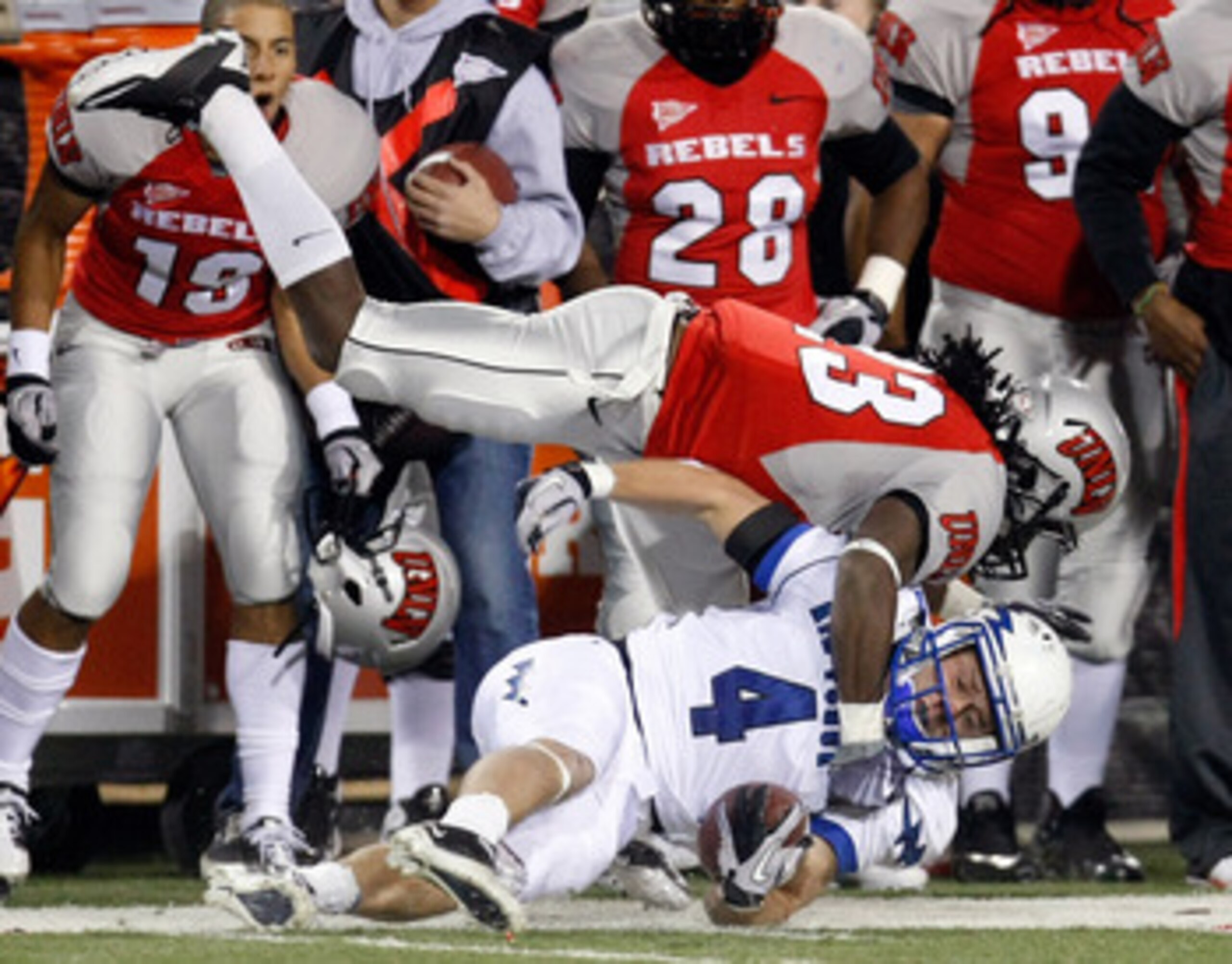 LAS VEGAS - NOVEMBER 18:  Kyle Halderman #4 of the Air Force Falcons is tackled by Sidney Hodge #23 of the UNLV Rebels during their game at Sam Boyd Stadium November 18, 2010 in Las Vegas, Nevada. Air Force won 35-20.  (Photo by Ethan Miller/Getty Images)