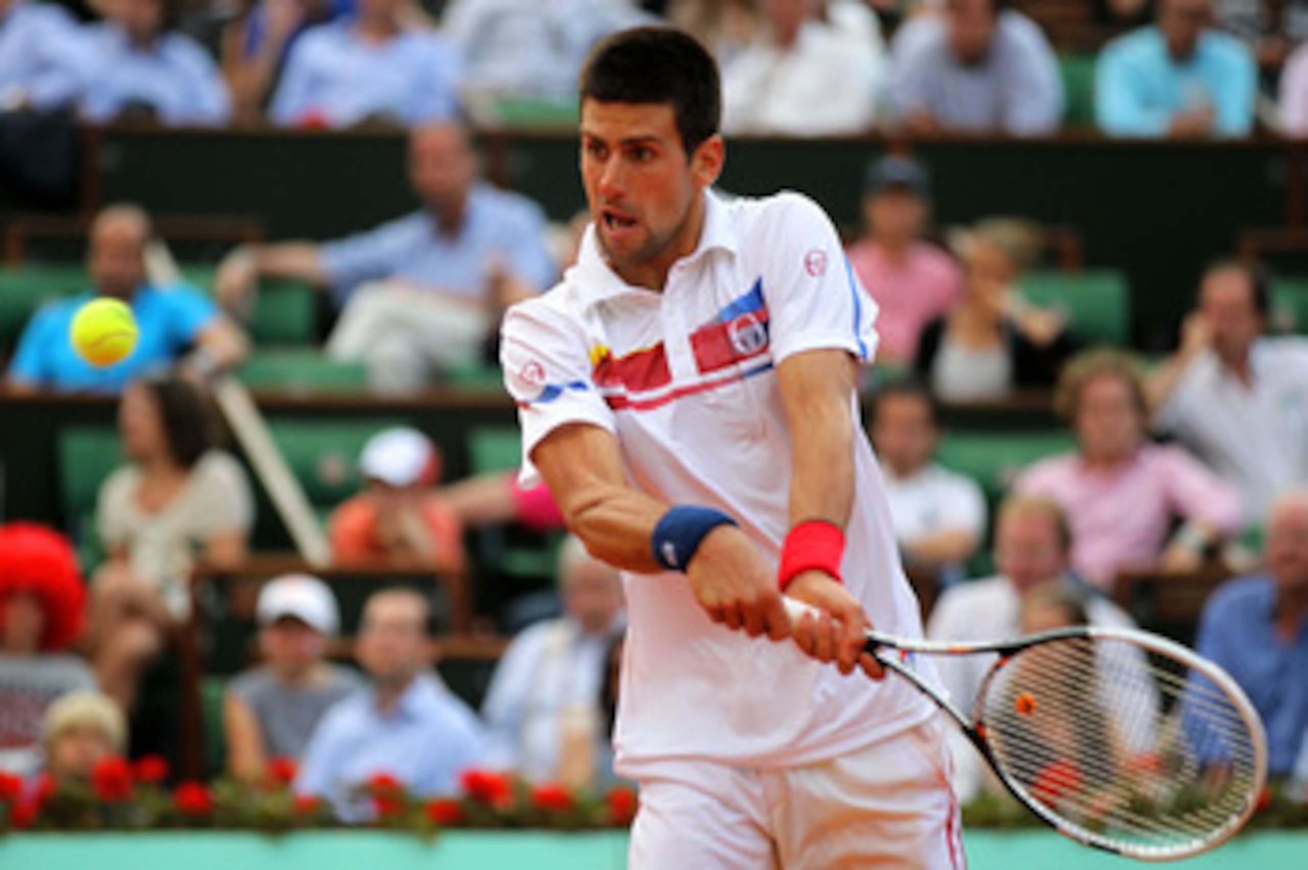 PARIS, FRANCE - JUNE 03:  Novak Djokovic of Serbia hits a backhand during the men's singles semi final match between Roger Federer of Switzerland and Novak Djokovic of Serbia on day thirteen of the French Open at Roland Garros on June 3, 2011 in Paris, Fr