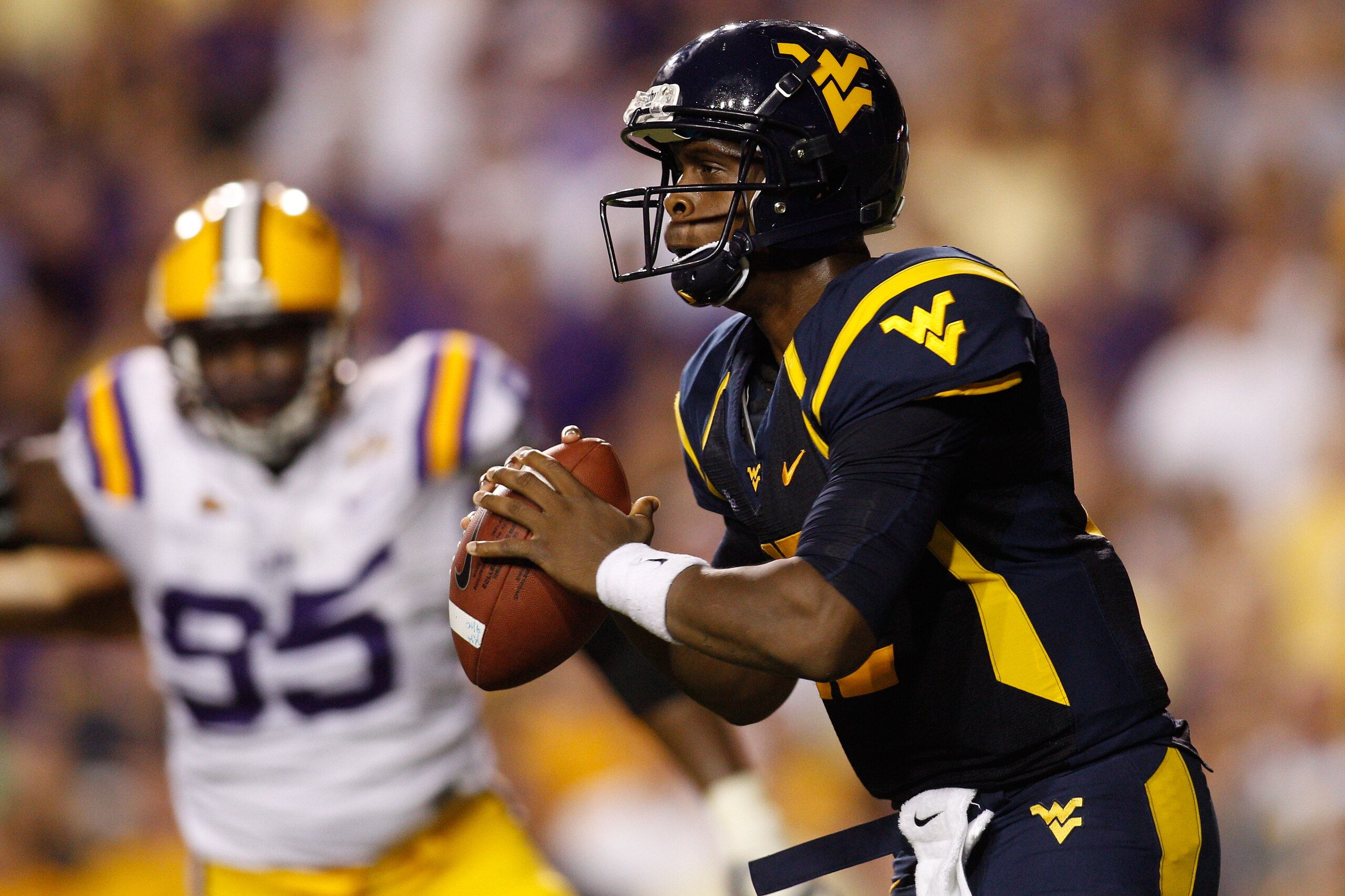 BATON ROUGE, LA - SEPTEMBER 25:  Quarterback Geno Smith #12 of the West Virginia Mountaineers looks to throw a pass against the Louisiana State University Tigers at Tiger Stadium on September 25, 2010 in Baton Rouge, Louisiana.  (Photo by Chris Graythen/G