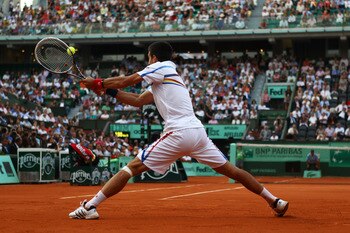 PARIS, FRANCE - JUNE 03:  Novak Djokovic of Serbia hits a backhand during the men's singles semi final match between Roger Federer of Switzerland and Novak Djokovic of Serbia on day thirteen of the French Open at Roland Garros on June 3, 2011 in Paris, Fr