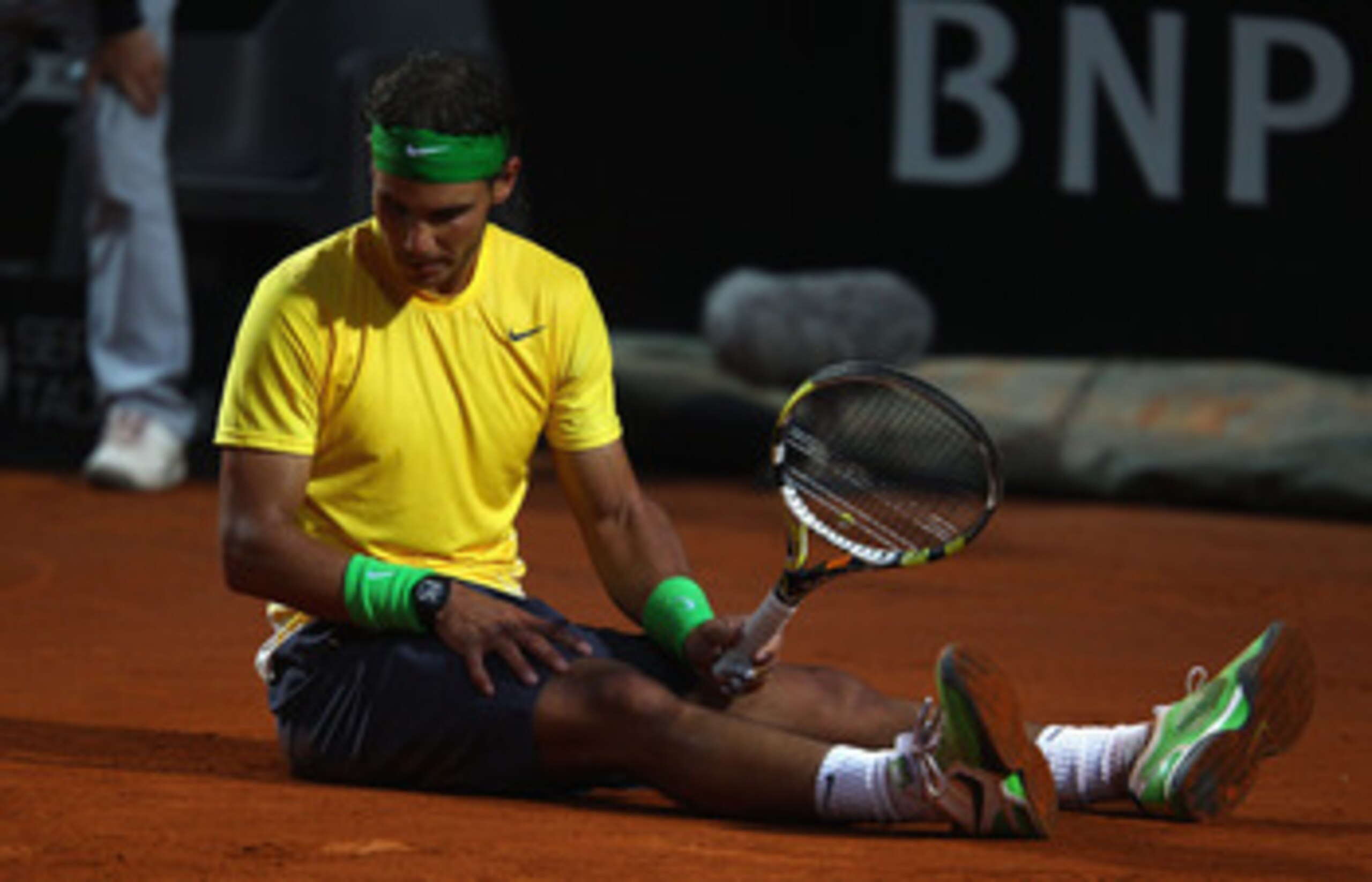 ROME, ITALY - MAY 15:  Rafael Nadal of Spain shows his dejection after falling during the final against Novak Djokovic of Serbia during day eight of the Internazoinali BNL D'Italia at the Foro Italico Tennis Centre on May 15, 2011 in Rome, Italy.  (Photo 