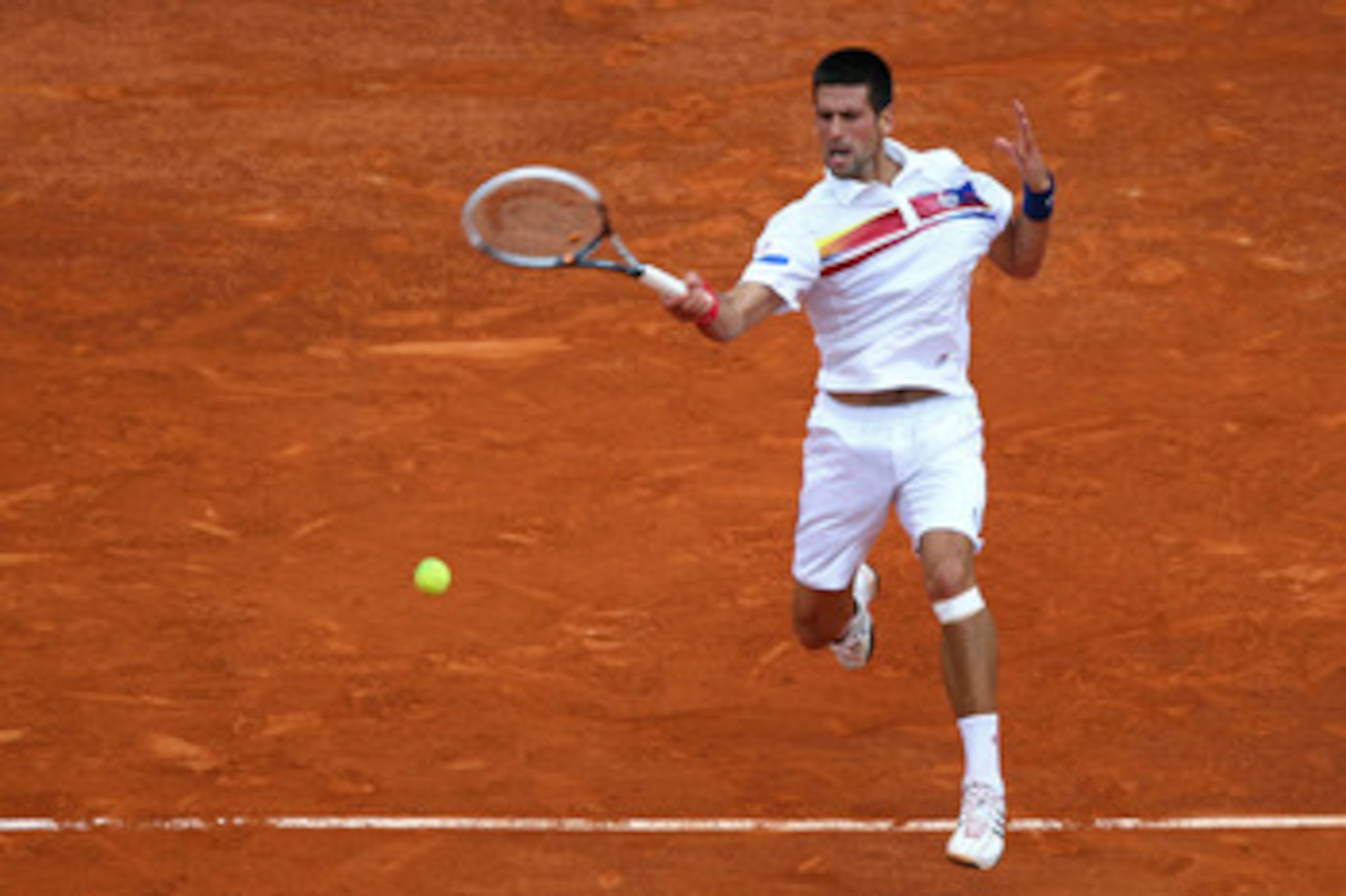 PARIS, FRANCE - JUNE 03:  Novak Djokovic of Serbia hits a forehand during the men's singles semi final match between Roger Federer of Switzerland and Novak Djokovic of Serbia on day thirteen of the French Open at Roland Garros on June 3, 2011 in Paris, Fr