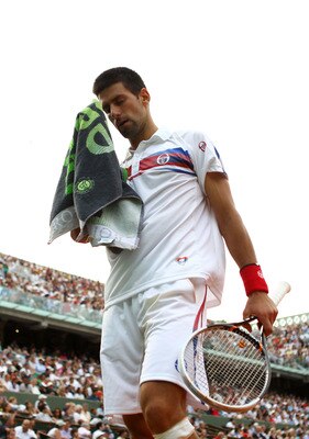 PARIS, FRANCE - JUNE 03:  Novak Djokovic of Serbia towels down between points during the men's singles semi final match between Roger Federer of Switzerland and Novak Djokovic of Serbia on day thirteen of the French Open at Roland Garros on June 3, 2011 i