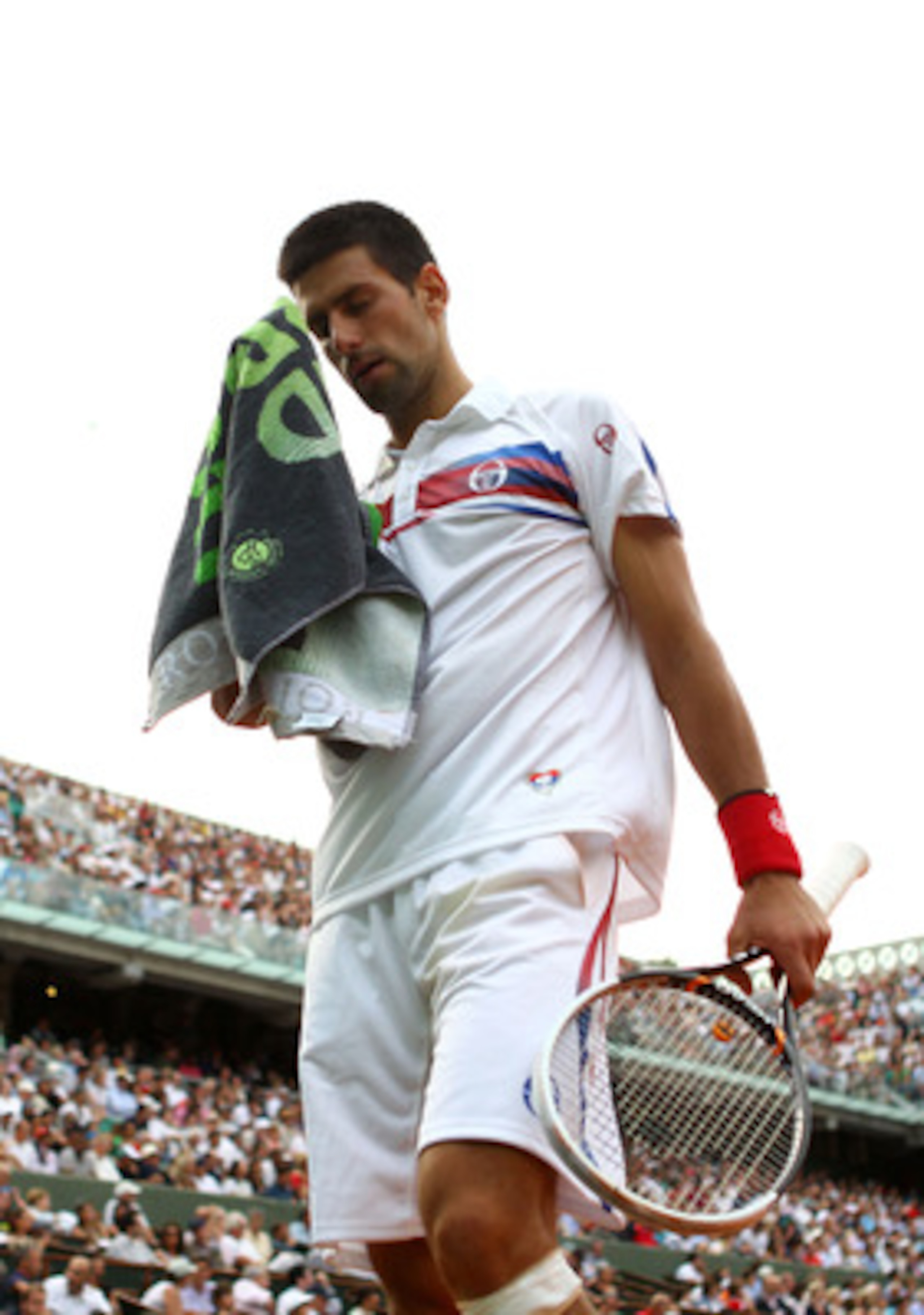 PARIS, FRANCE - JUNE 03:  Novak Djokovic of Serbia towels down between points during the men's singles semi final match between Roger Federer of Switzerland and Novak Djokovic of Serbia on day thirteen of the French Open at Roland Garros on June 3, 2011 i