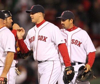 BOSTON, MA - APRIL 10: Jason Varitek #33, Jonathan Papelbon #58 and Adrian Gonzalez #28 of the Boston Red Sox celebrate a win against the New York Yankees at Fenway Park April 10, 2011 in Boston, Massachusetts. (Photo by Jim Rogash/Getty Images)
