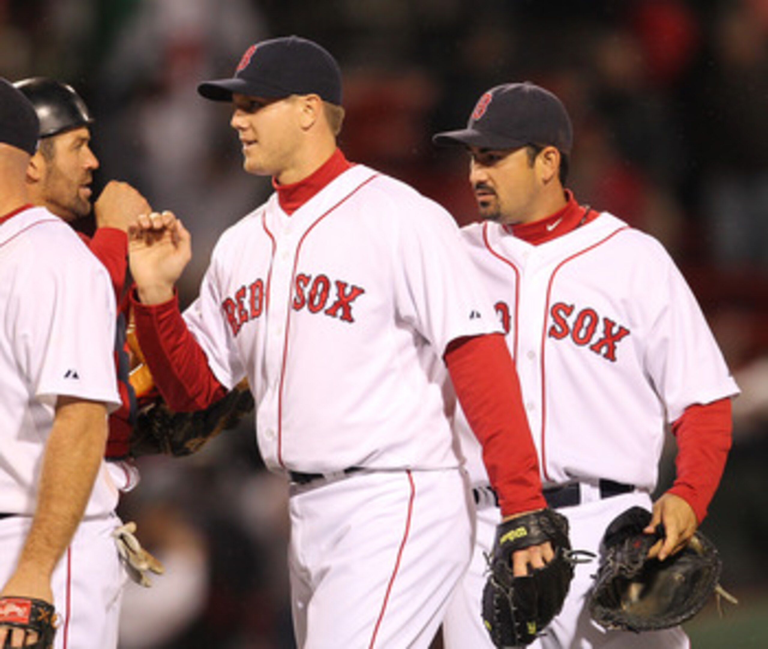 BOSTON, MA - APRIL 10: Jason Varitek #33, Jonathan Papelbon #58 and Adrian Gonzalez #28 of the Boston Red Sox celebrate a win against the New York Yankees at Fenway Park April 10, 2011 in Boston, Massachusetts. (Photo by Jim Rogash/Getty Images)