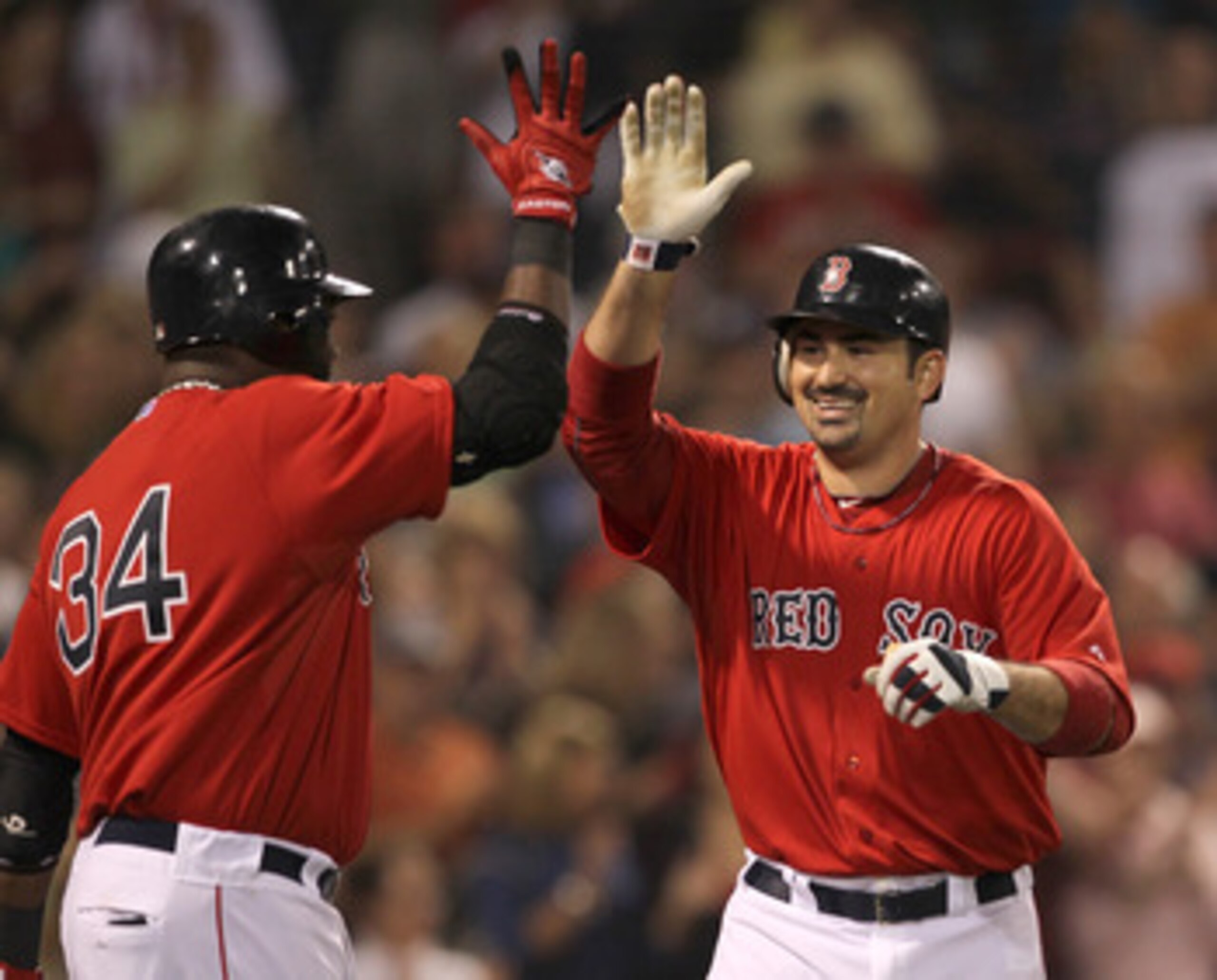 BOSTON, MA  - JUNE 17:  Adrian Gonzalez #28 of the Boston Red Sox celebrates his home run with teammate David Ortiz #34 in the fifth inning against the Milwaukee Brewers at Fenway Park on June 17, 2011 in Boston, Massachusetts.  (Photo by Jim Rogash/Getty