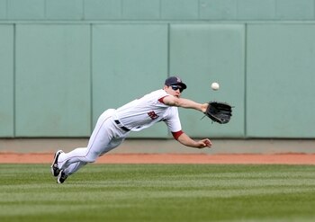 BOSTON - OCTOBER 11:  Jacoby Ellsbury #46 of the Boston Red Sox makes a diving catch on a Bobby Abreu #53 of the Los Angeles Angels of Anaheim flyout in the third inning of Game Three of the ALDS during the 2009 MLB Playoffs at Fenway Park on October 11, 