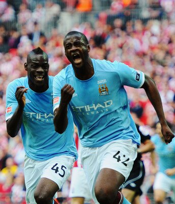 LONDON, ENGLAND - MAY 14:  Yaya Toure (R) of Manchester City celebrates with Mario Balotelli (L) after scoring during the FA Cup sponsored by E.ON Final match between Manchester City and Stoke City at Wembley Stadium on May 14, 2011 in London, England.  (