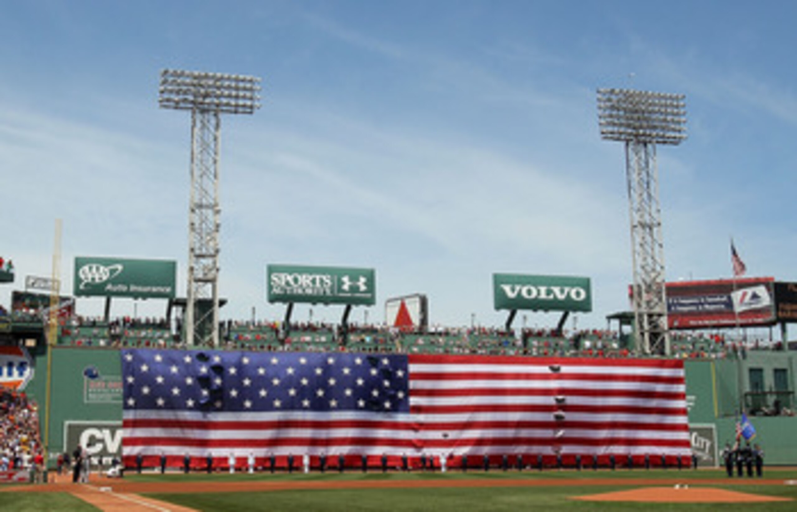 BOSTON - JULY 04:  Jets fly over as a giant flag covers the Green Monster before the game between the Baltimore Orioles and  the Boston Red Sox on July 4, 2010 at Fenway Park in Boston, Massachusetts.  (Photo by Elsa/Getty Images)