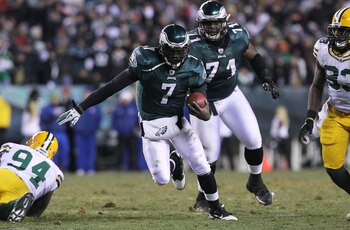 PHILADELPHIA, PA - JANUARY 09:  Michael Vick #7 of the Philadelphia Eagles runs down field against Jarius Wynn #94 of the Green Bay Packers during the 2011 NFC wild card playoff game at Lincoln Financial Field on January 9, 2011 in Philadelphia, Pennsylva