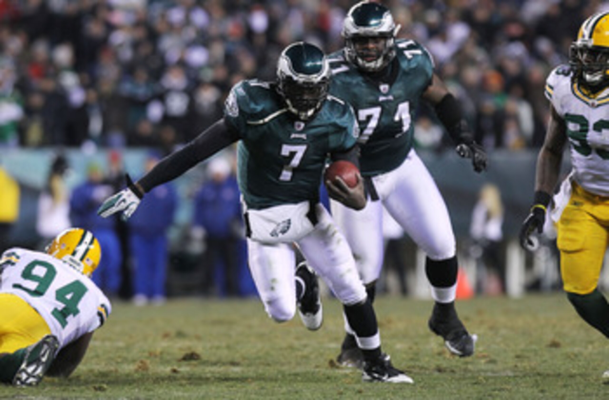 PHILADELPHIA, PA - JANUARY 09:  Michael Vick #7 of the Philadelphia Eagles runs down field against Jarius Wynn #94 of the Green Bay Packers during the 2011 NFC wild card playoff game at Lincoln Financial Field on January 9, 2011 in Philadelphia, Pennsylva
