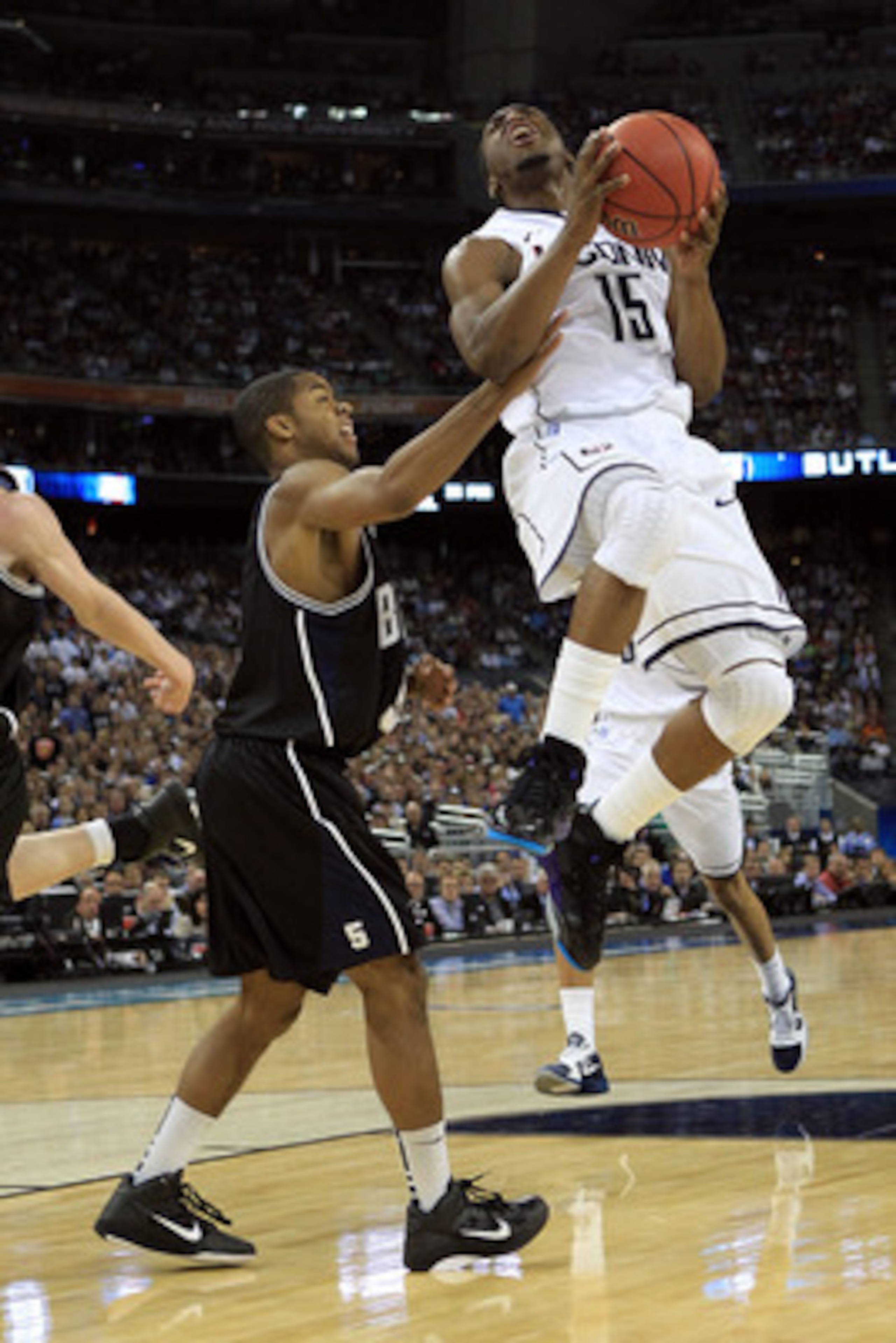 HOUSTON, TX - APRIL 04:  Kemba Walker #15 of the Connecticut Huskies goes to the basket against Ronald Nored #5 of the Butler Bulldogs during the National Championship Game of the 2011 NCAA Division I Men's Basketball Tournament at Reliant Stadium on Apri