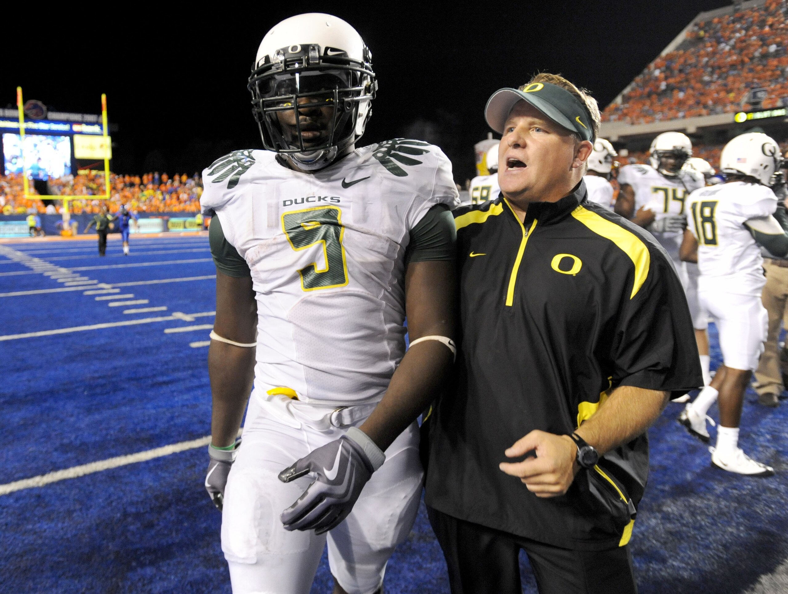 BOISE, ID - SEPTEMBER 3:  LaGarrette Blount #9 of the Oregon Ducks is escorted off the field by head coach Chip Kelly after Blount punched defensive end Byron Hout  #94 (not in photo)  of the Boise State Broncos after Boise State defeated Oregon 19-8 on S