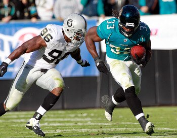 JACKSONVILLE, FL - DECEMBER 12:  Kamerion Wimbley #96 of the Oakland Raiders attempts to tackle Greg Jones #33 of the Jacksonville Jaguars runs during the game at EverBank Field on December 12, 2010 in Jacksonville, Florida.  (Photo by Sam Greenwood/Getty